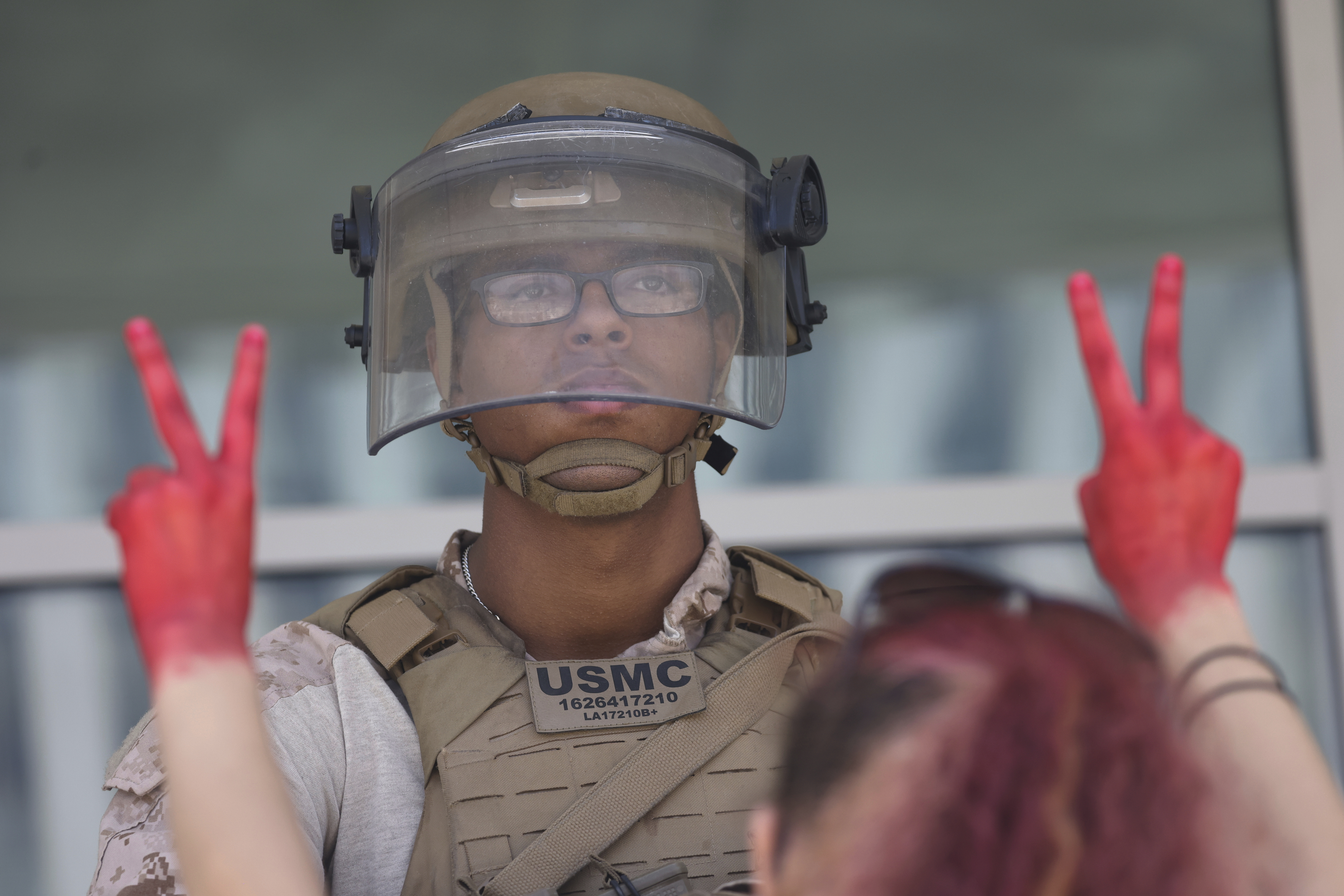 Protesters confront Marines outside the Federal Building on Friday, July 4, 2025 in Los Angeles. (AP Photo/Jill Connelly)