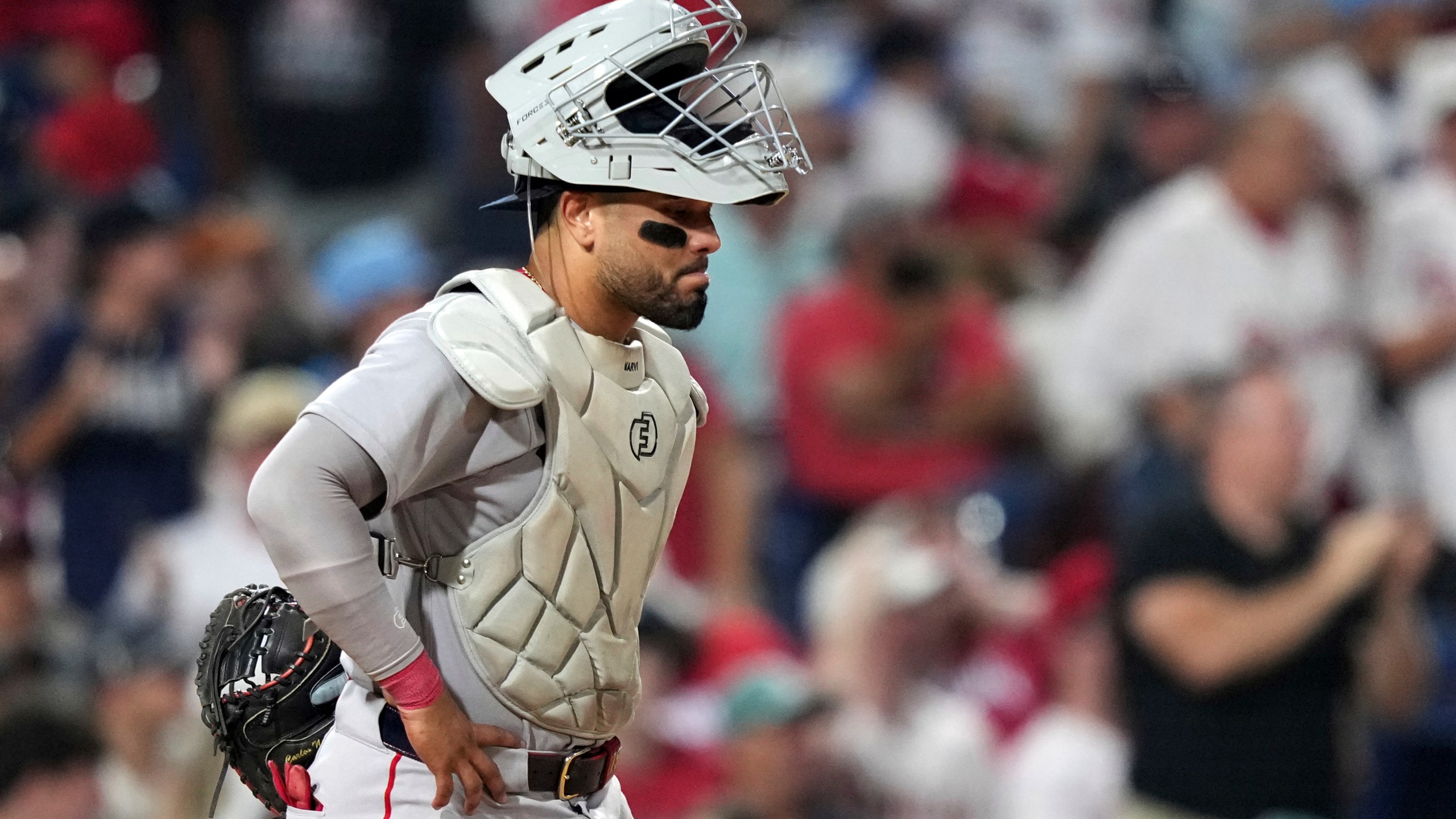 Boston Red Sox catcher Carlos Narváez waits for umpires to call catcher's interference on him during an at-bat by Philadelphia Phillies' Edmundo Sosa with the bases loaded during the 10th inning of a baseball game Monday, July 21, 2025, in Philadelphia. (AP Photo/Matt Slocum)