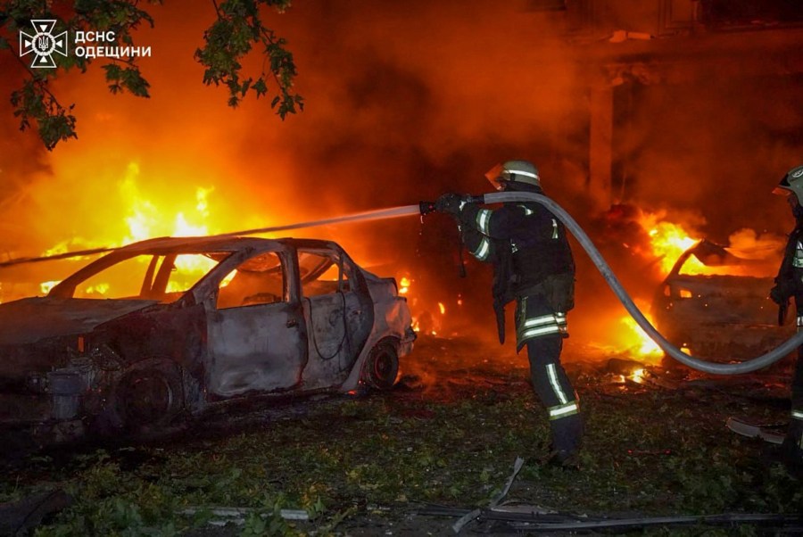 In this photo provided by the Ukrainian Emergency Service, emergency services personnel work to extinguish a fire following a Russian attack in Odesa, Ukraine, Tuesday, July 22, 2025. (Ukrainian Emergency Service via AP)
