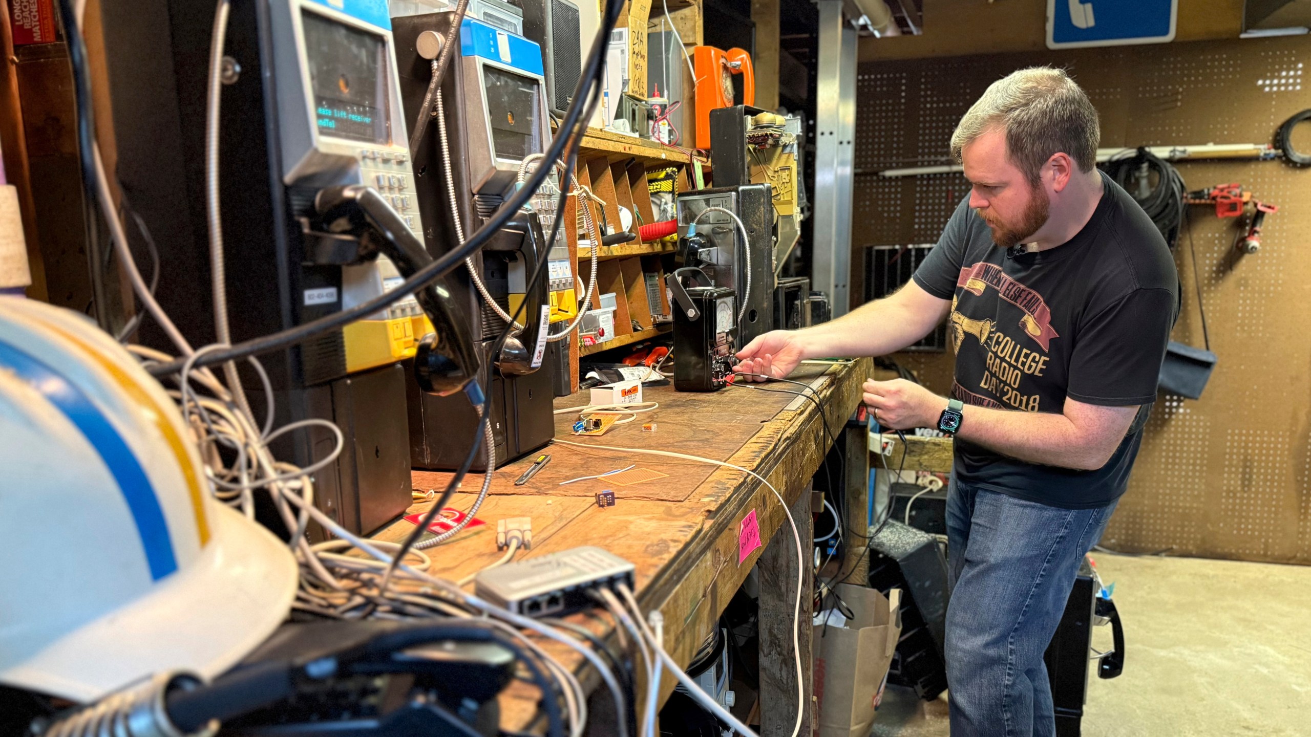Patrick Schlott repairs an old payphone in his basement workshop on July 16, 2025 in Williamstown, Vt. (AP Photo/Amanda Swinhart)