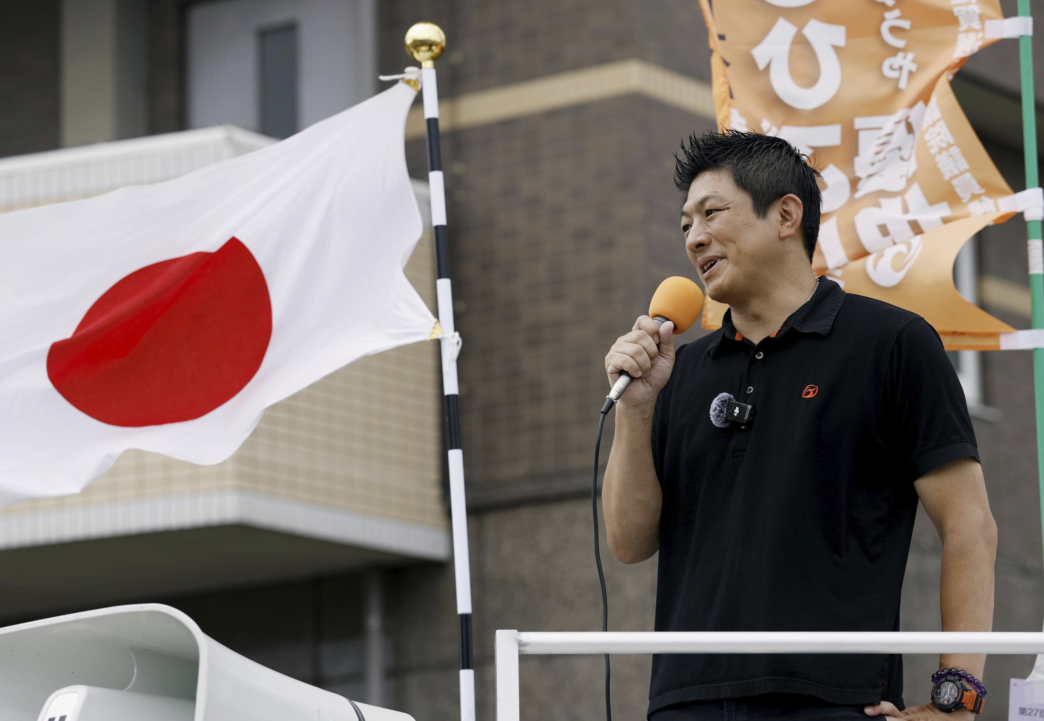 Sohei Kamiya, leader of the Sanseito party, speaks during an election campaign in Tosu, Saga prefecture, southwestern Japan, on July 12, 2025. (Kyodo News via AP)