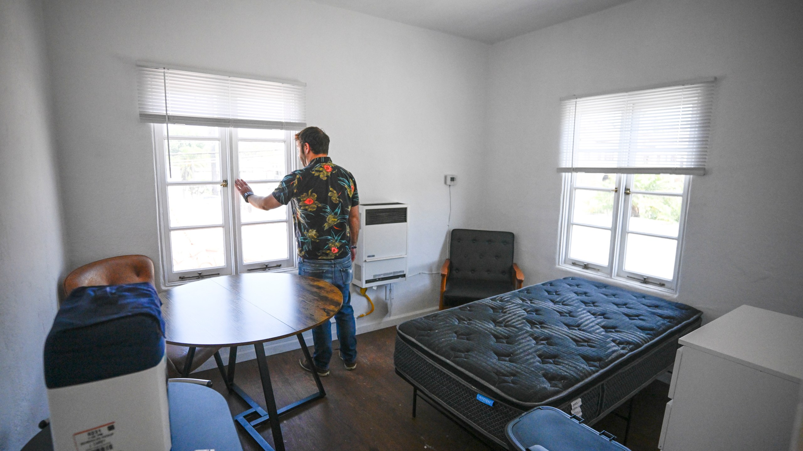 James Carey, housing director for the Friendship Shelter, gives a tour of the one of the apartments that the organization provides for homeless people, Monday, July 7, 2025, in San Clemente, Calif. (AP Photo/Denis Poroy)