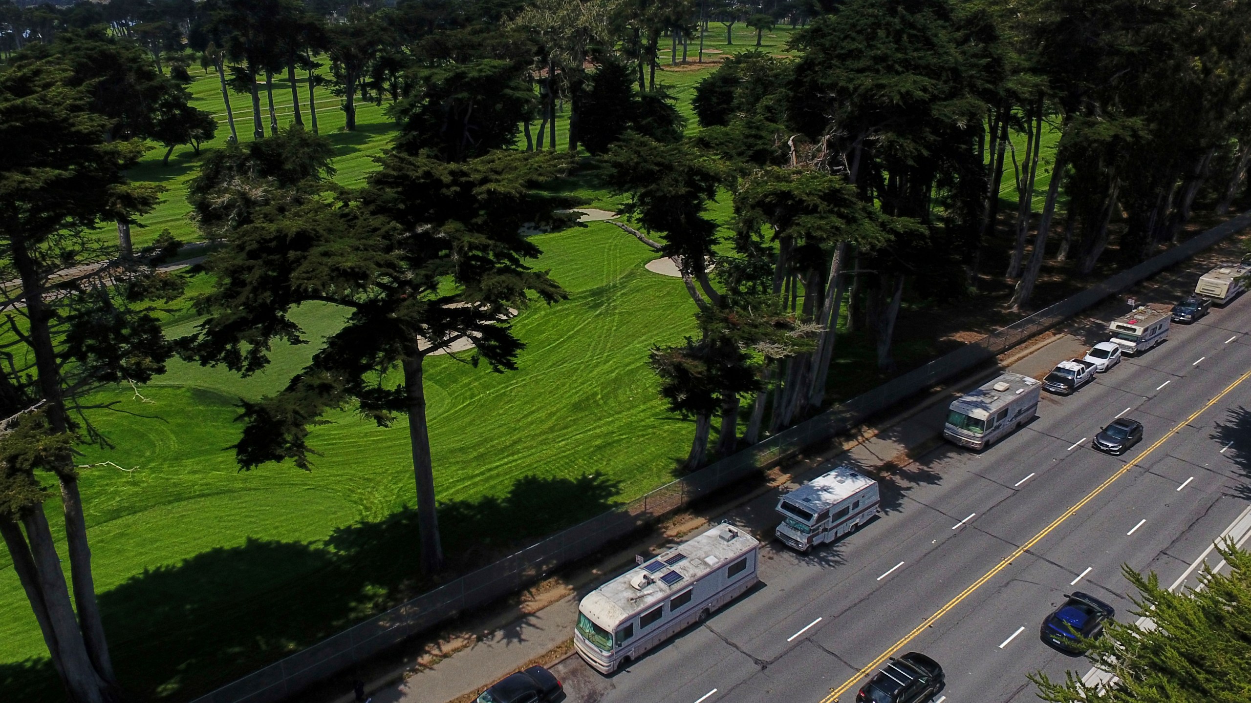 Motorists travel past RVs parked on Lake Merced Boulevard in San Francisco, Tuesday, July 15, 2025. (AP Photo/Godofredo A. Vásquez)