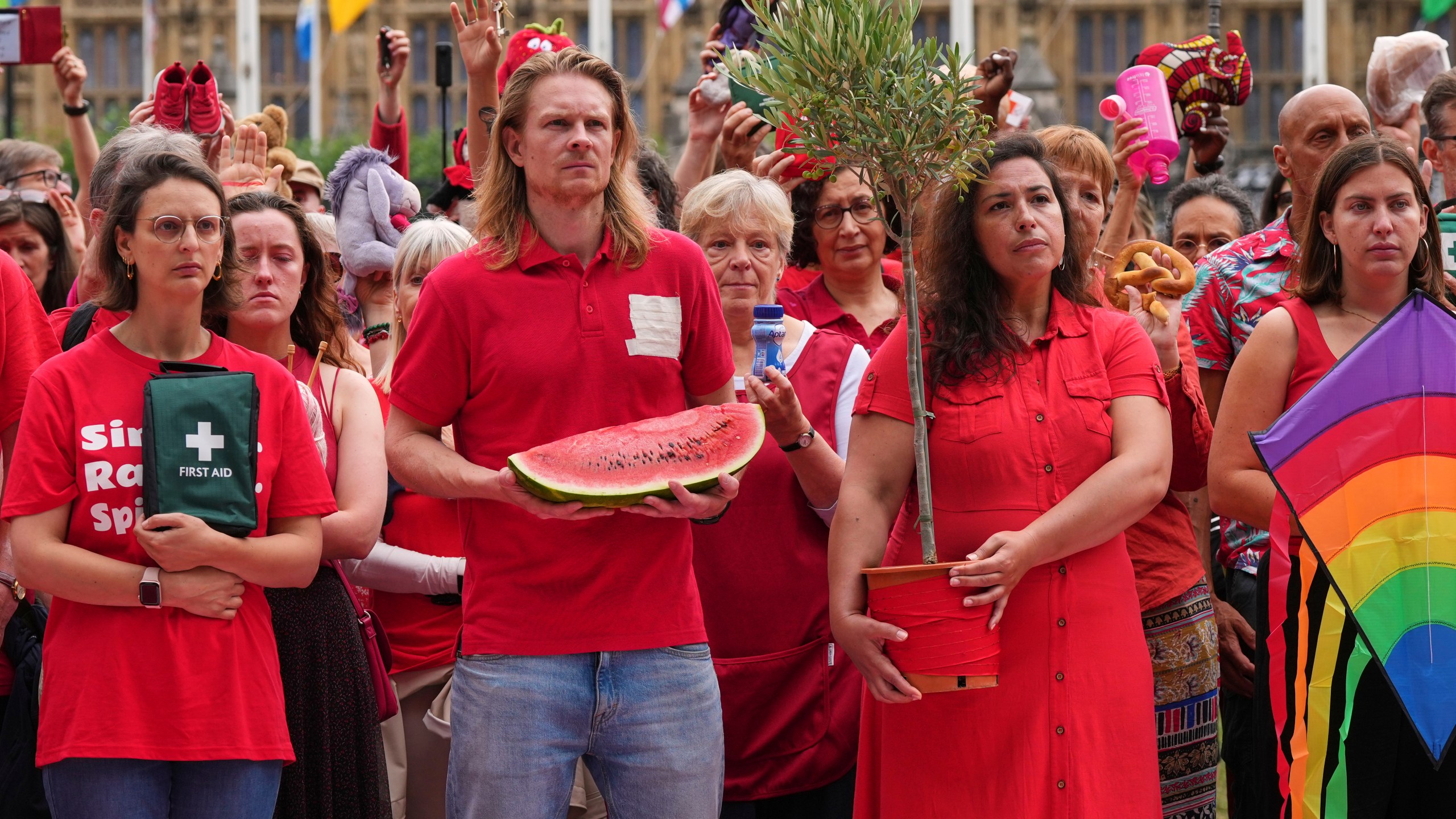 Members of the public wearing red demonstrate outside Parliament to protest the treatment of people in Gaza on the final day before summer recess at Parliament Square in London, Tuesday, July 22, 2025. (AP Photo/Frank Augstein)