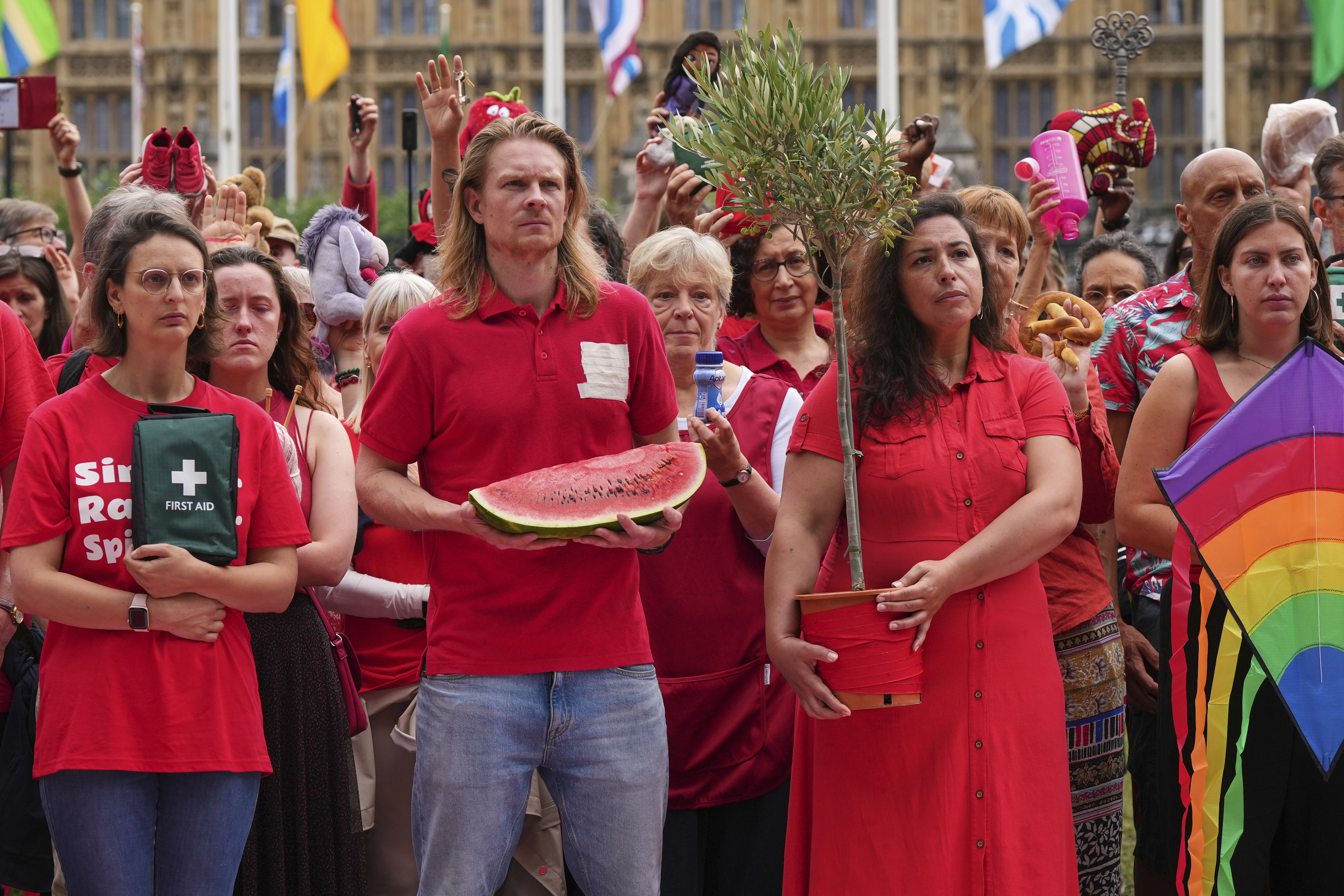 Members of the public wearing red demonstrate outside Parliament to protest the treatment of people in Gaza on the final day before summer recess at Parliament Square in London, Tuesday, July 22, 2025. (AP Photo/Frank Augstein)