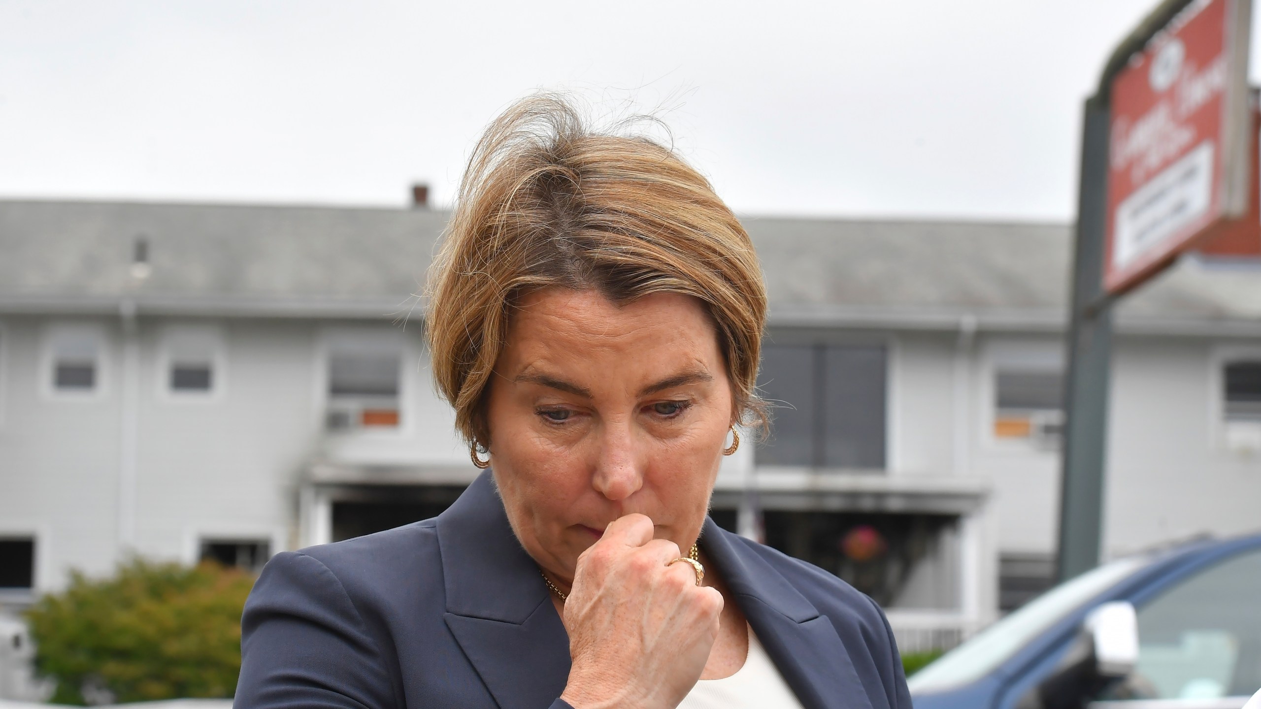 FILE - Massachusetts Gov. Maura Healey approaches a news conference to face reporters, July 14, 2025, near the Gabriel House assisted living facility, behind, following a fire that started late Sunday in Fall River, Mass. (AP Photo/Steven Senne, file)