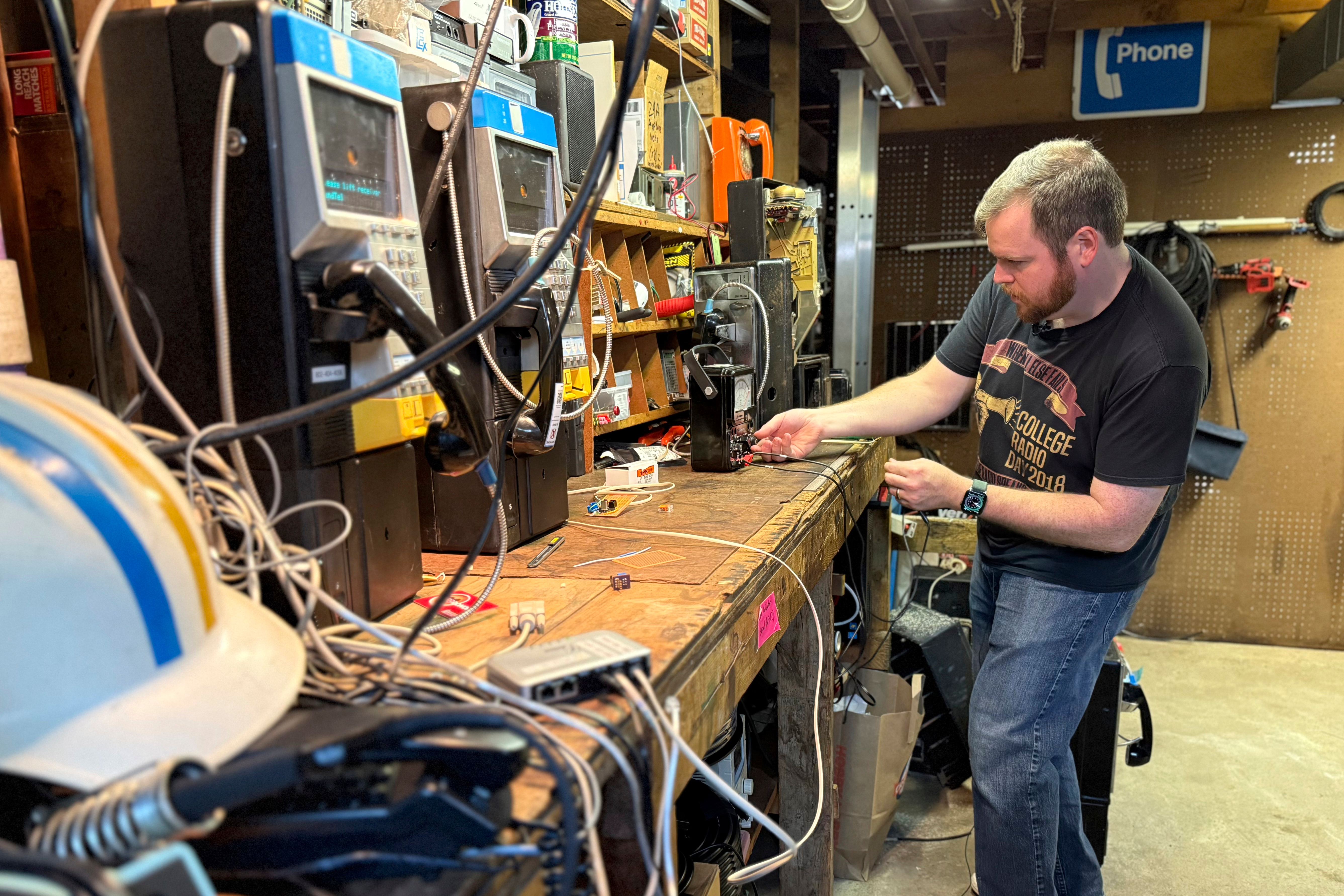 Patrick Schlott repairs an old payphone in his basement workshop on July 16, 2025 in Williamstown, Vt. (AP Photo/Amanda Swinhart)