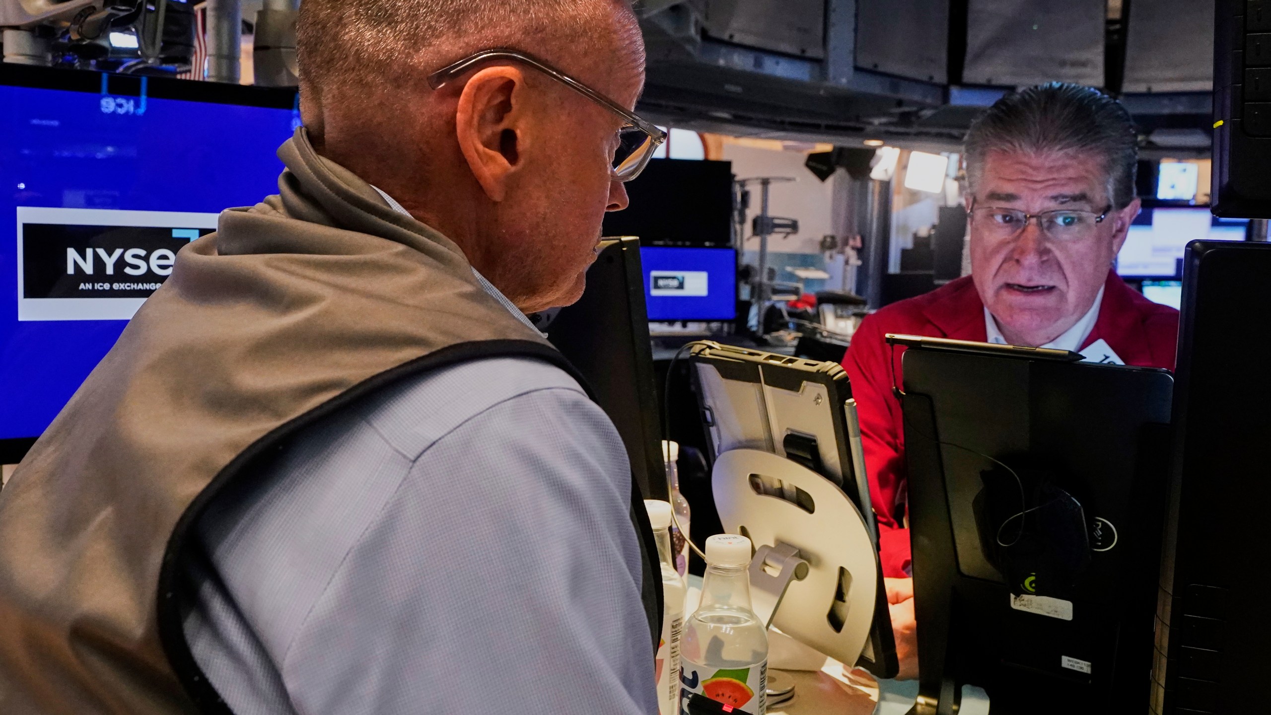 Traders Neil Catania, left, and Daniel Kryger work on the floor of the New York Stock Exchange, Monday, July 21, 2025. (AP Photo/Richard Drew)