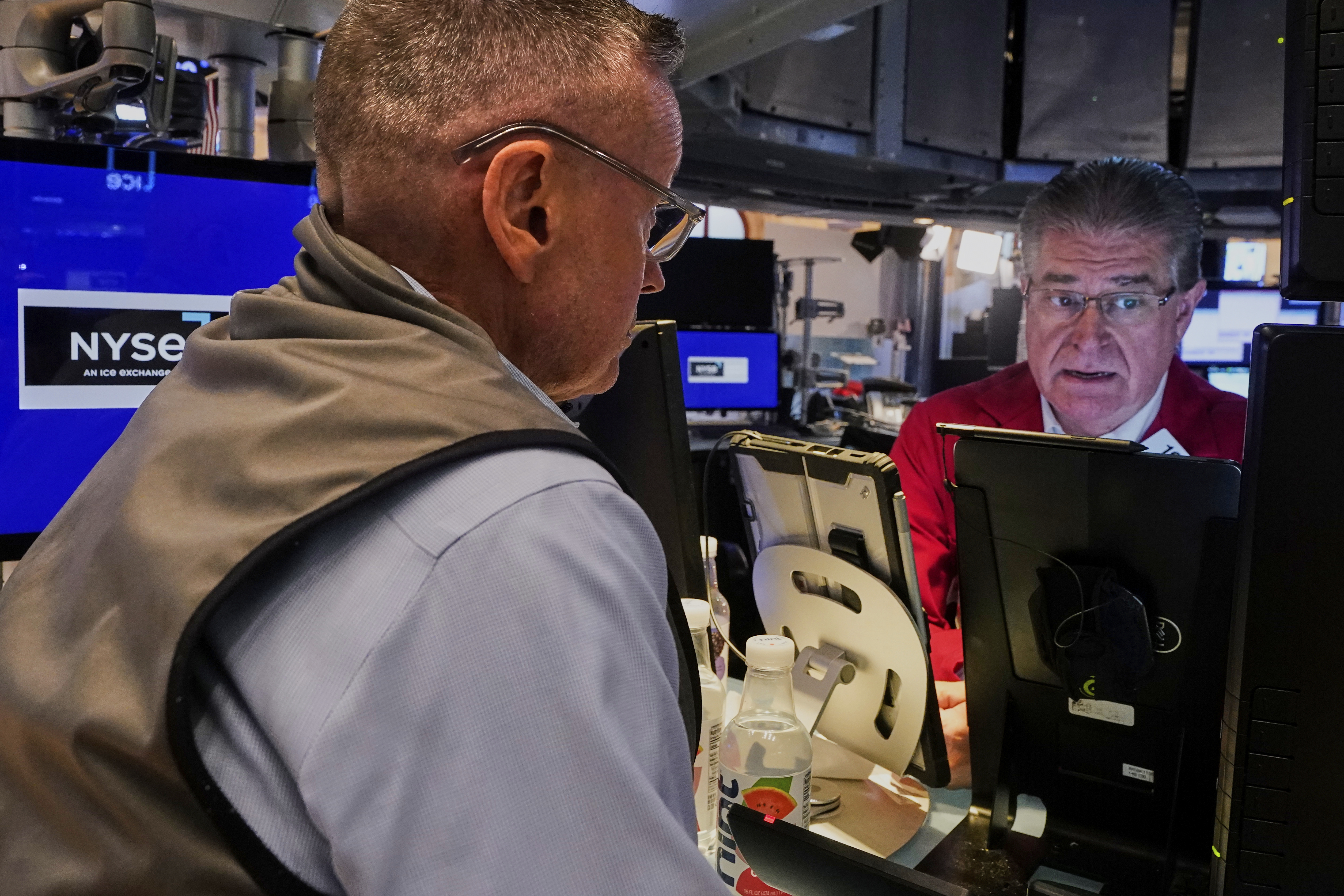 Traders Neil Catania, left, and Daniel Kryger work on the floor of the New York Stock Exchange, Monday, July 21, 2025. (AP Photo/Richard Drew)