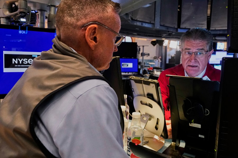 Traders Neil Catania, left, and Daniel Kryger work on the floor of the New York Stock Exchange, Monday, July 21, 2025. (AP Photo/Richard Drew)