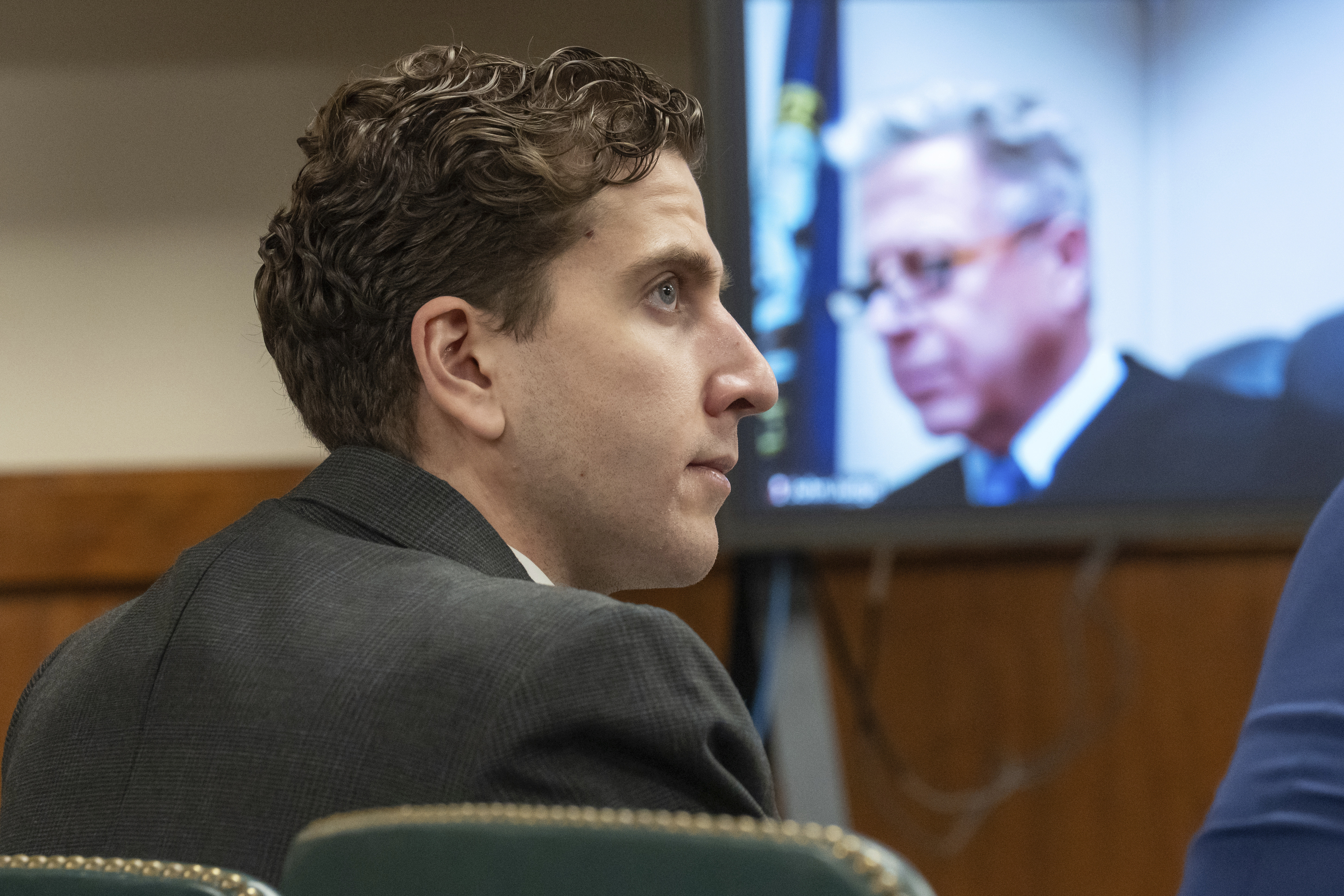 FILE - Bryan Kohberger, left, who is accused of killing four University of Idaho students in November 2022, appears at a hearing in Latah County District Court, Sept. 13, 2023, in Moscow, Idaho, as Second District Judge John C. Judge, seen on a video display, presides over the hearing. (AP Photo/Ted S. Warren, Pool, File)