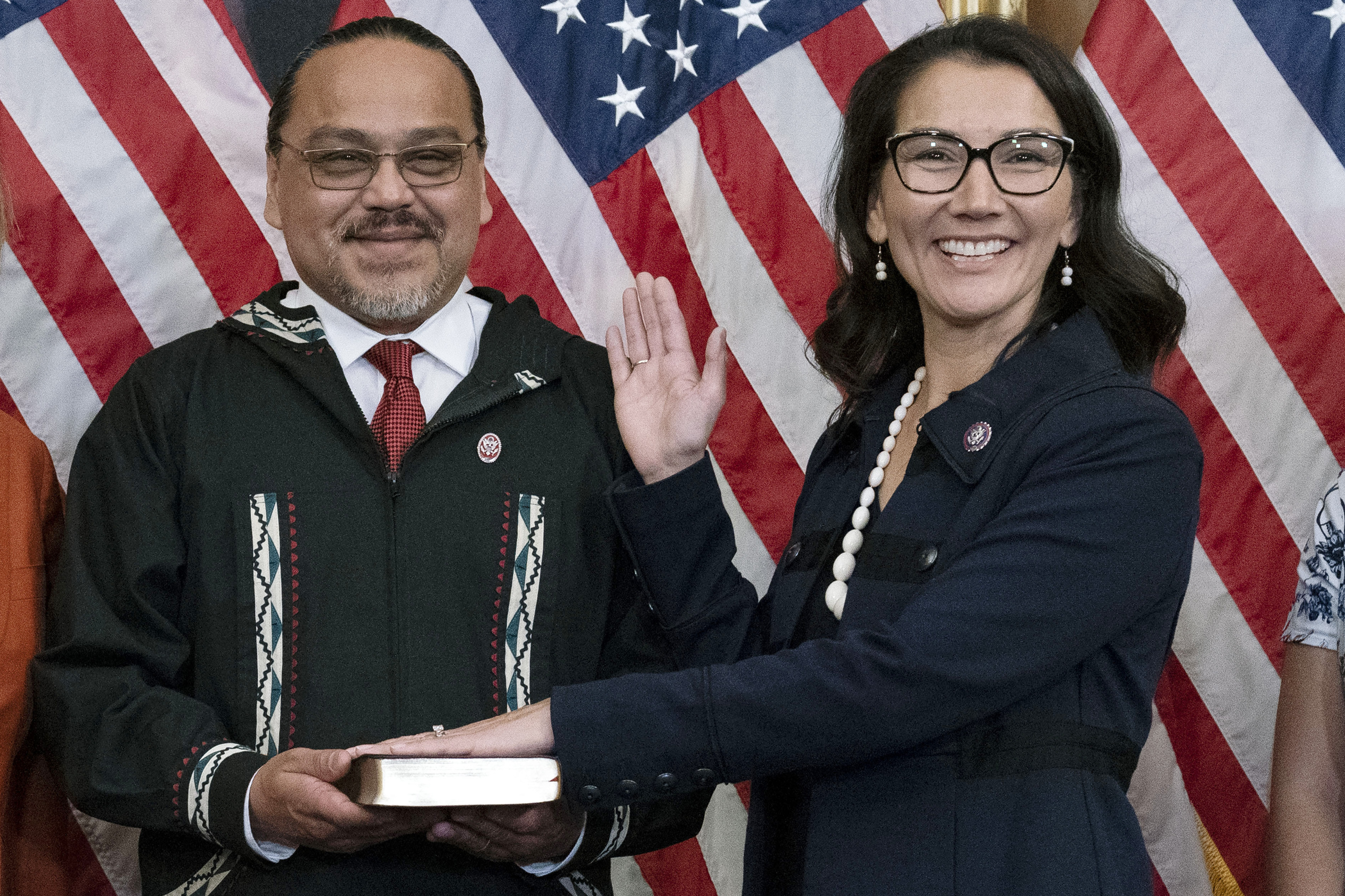 FILE - Eugene "Buzzy" Peltola Jr. holds the Bible during a ceremonial swearing-in for his wife, Rep. Mary Peltola, D-Alaska, on Capitol Hill in Washington, Sept. 13, 2022. (AP Photo/Jose Luis Magana, File)