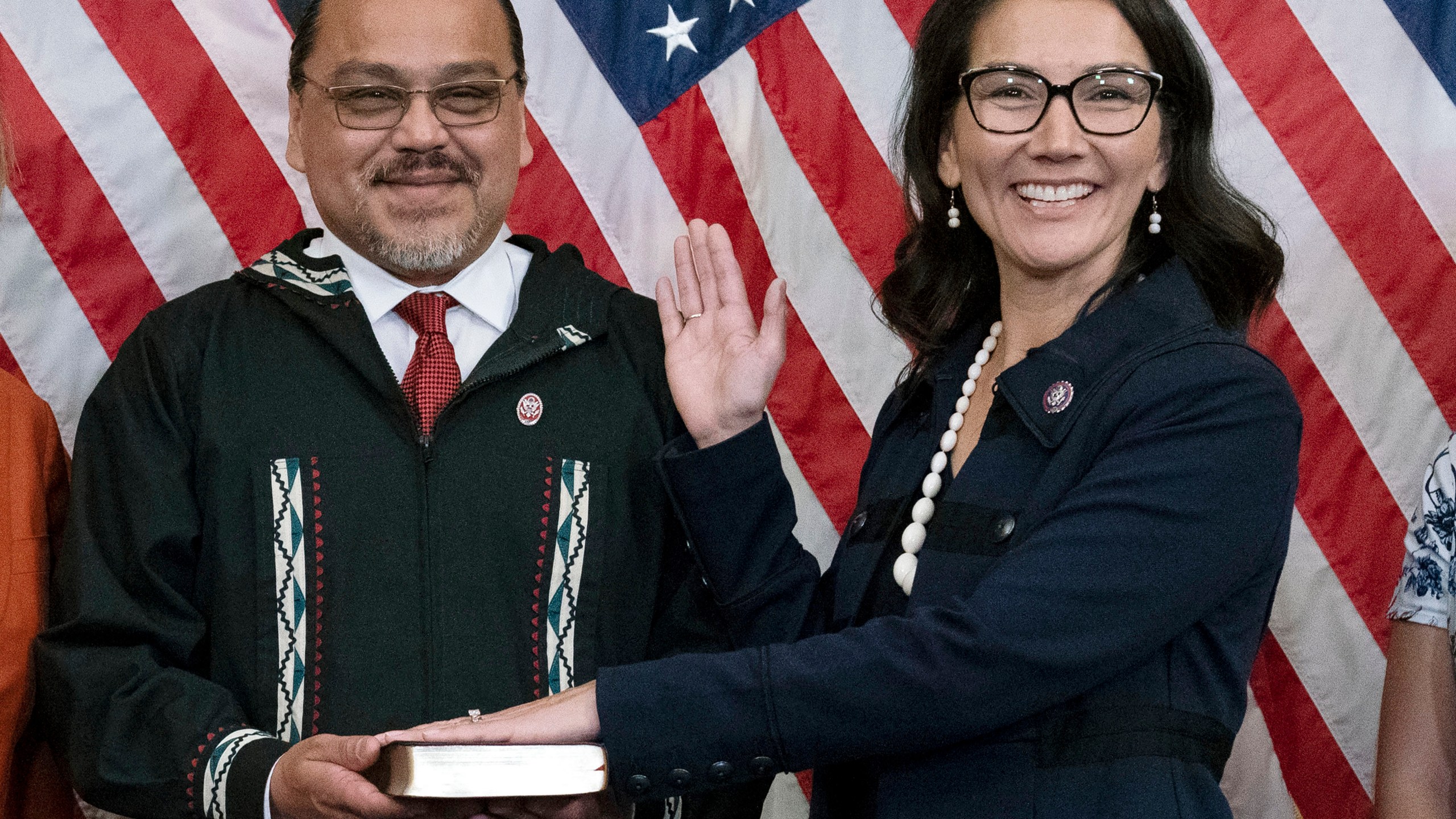 FILE - Eugene "Buzzy" Peltola Jr. holds the Bible during a ceremonial swearing-in for his wife, Rep. Mary Peltola, D-Alaska, on Capitol Hill in Washington, Sept. 13, 2022. (AP Photo/Jose Luis Magana, File)