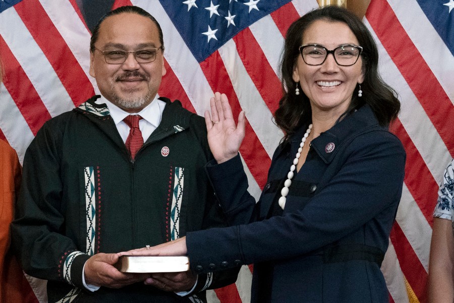FILE - Eugene "Buzzy" Peltola Jr. holds the Bible during a ceremonial swearing-in for his wife, Rep. Mary Peltola, D-Alaska, on Capitol Hill in Washington, Sept. 13, 2022. (AP Photo/Jose Luis Magana, File)