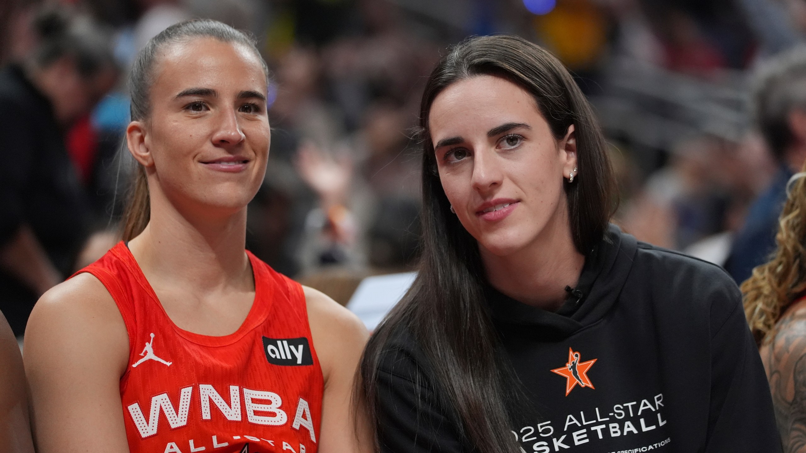 New York Liberty's Sabrina Ionescu, left, talks with Indiana Fever's Caitlin Clark during the second half of a WNBA All-Star basketball game against Team Collier, Saturday, July 19, 2025, in Indianapolis. (AP Photo/Michael Conroy)