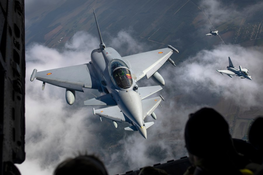FILE -Spanish Air Force Eurofighter Typhoon military fighter jets, left, and Italian Air Force Eurofighter Typhoon military fighter jets, right, participating in NATO's Baltic Air Policing Mission operate in Lithuanian airspace,, Sept.12, 2023. (AP Photo/Mindaugas Kulbis, File)