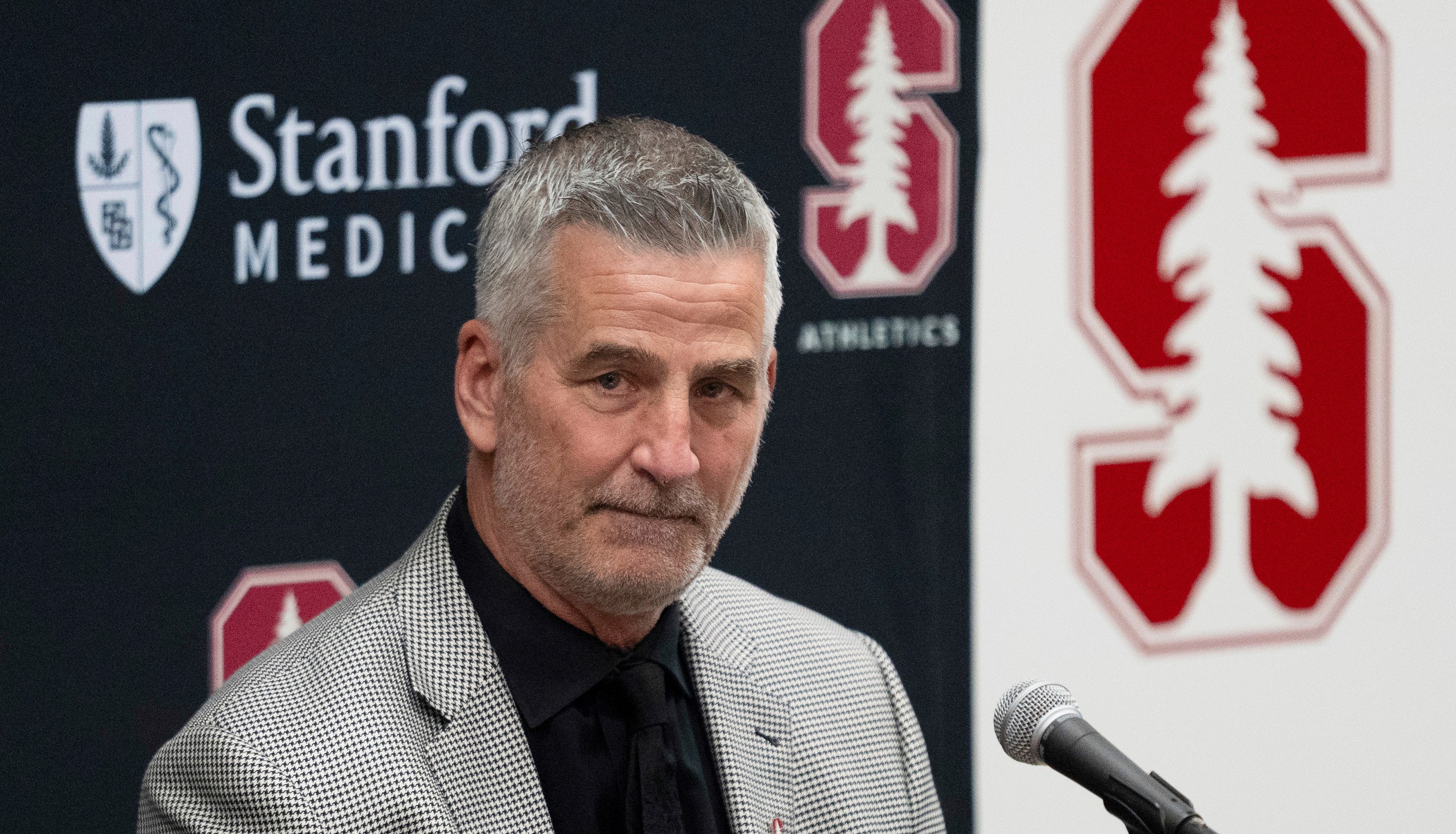 FILE - Stanford's new coach Frank Reich listens as he's introduced during NCAA college football news conference, Tuesday, April 1, 2025, in Stanford, Calif. (AP Photo/Emily Steinberger, File)