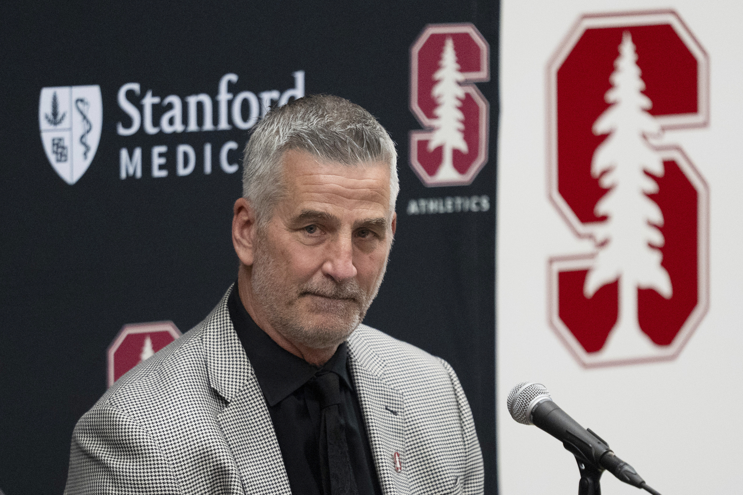 FILE - Stanford's new coach Frank Reich listens as he's introduced during NCAA college football news conference, Tuesday, April 1, 2025, in Stanford, Calif. (AP Photo/Emily Steinberger, File)