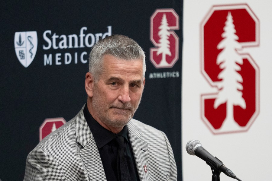 FILE - Stanford's new coach Frank Reich listens as he's introduced during NCAA college football news conference, Tuesday, April 1, 2025, in Stanford, Calif. (AP Photo/Emily Steinberger, File)