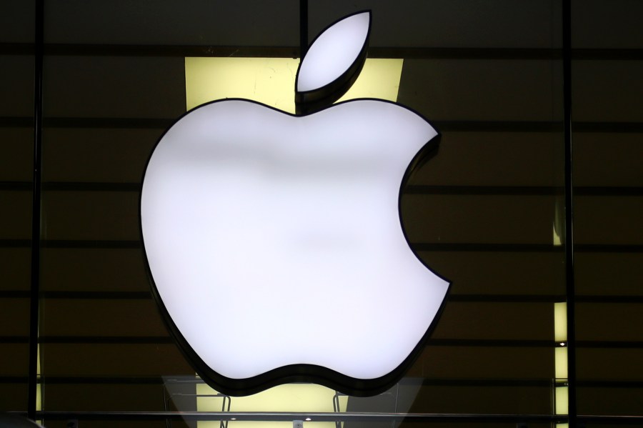 FILE - The Apple logo is illuminated at a store in the city center of Munich, Germany, Dec. 16, 2020. (AP Photo/Matthias Schrader, File)