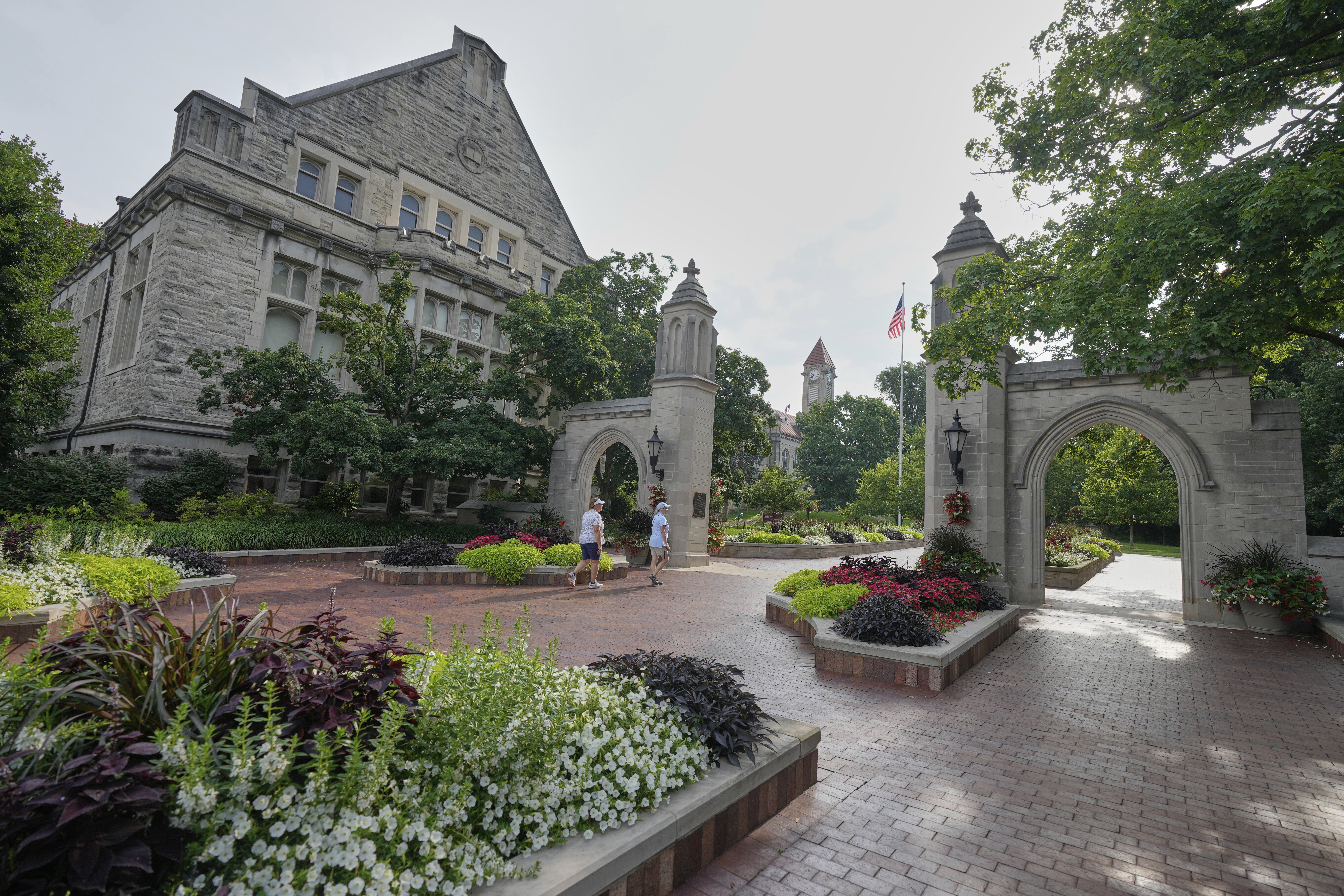 Guests walk on the campus of Indiana University, Thursday, July 17, 2025, in Bloomington, Ind. (AP Photo/Darron Cummings)