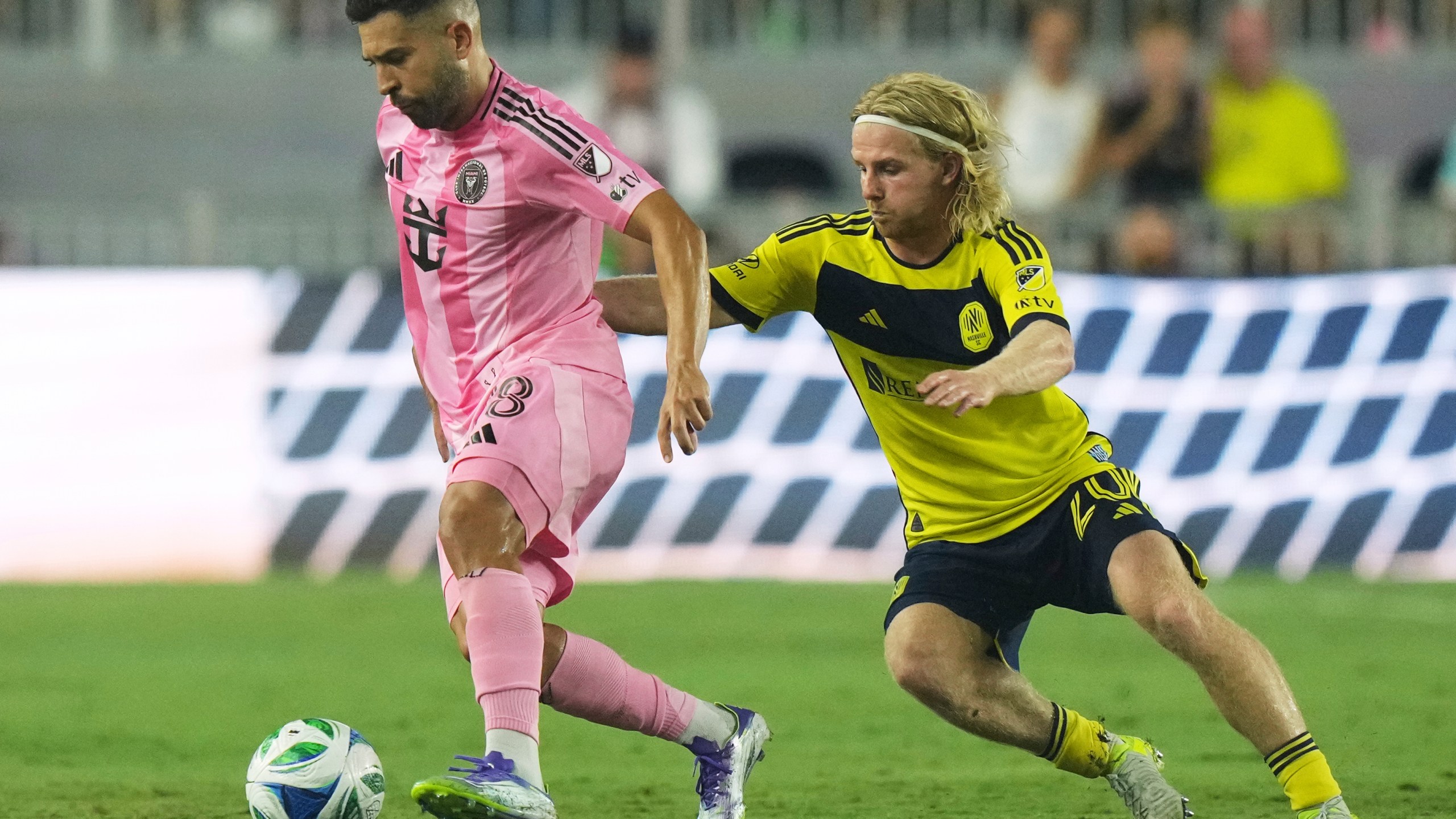 Inter Miami defender Jordi Alba (18) runs with the ball as Nashville SC midfielder Edvard Tagseth (20) defends during the second half of an MLS soccer match, Saturday, July 12, 2025, in Fort Lauderdale, Fla. (AP Photo/Lynne Sladky)