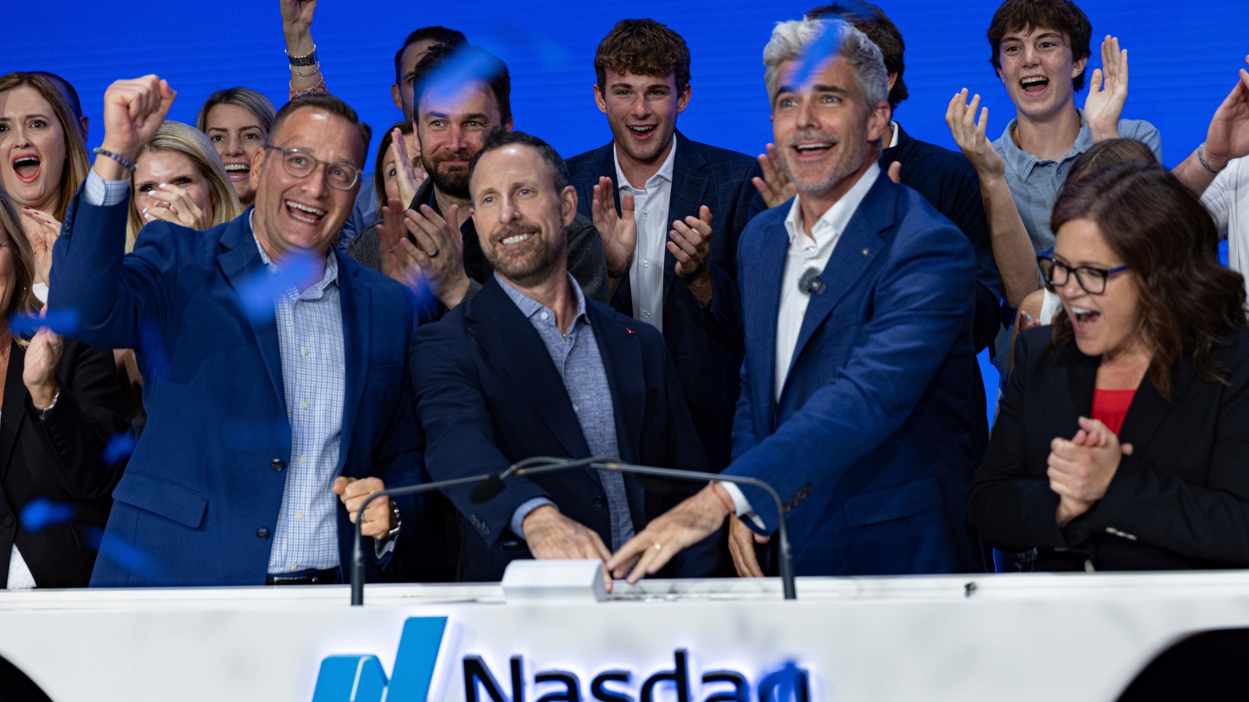 Jeffrey Housenbold, CEO and president of MrBeast, center, participates in a closing bell ceremony with MrBeast's "Beast Games" winner Jeffrey Allen, right, and Joe Brantuk, Nasdaq chief client officer, left, at their studio Wednesday, July 23, 2025, in New York's Times Square. (AP Photo/Stefan Jeremiah)