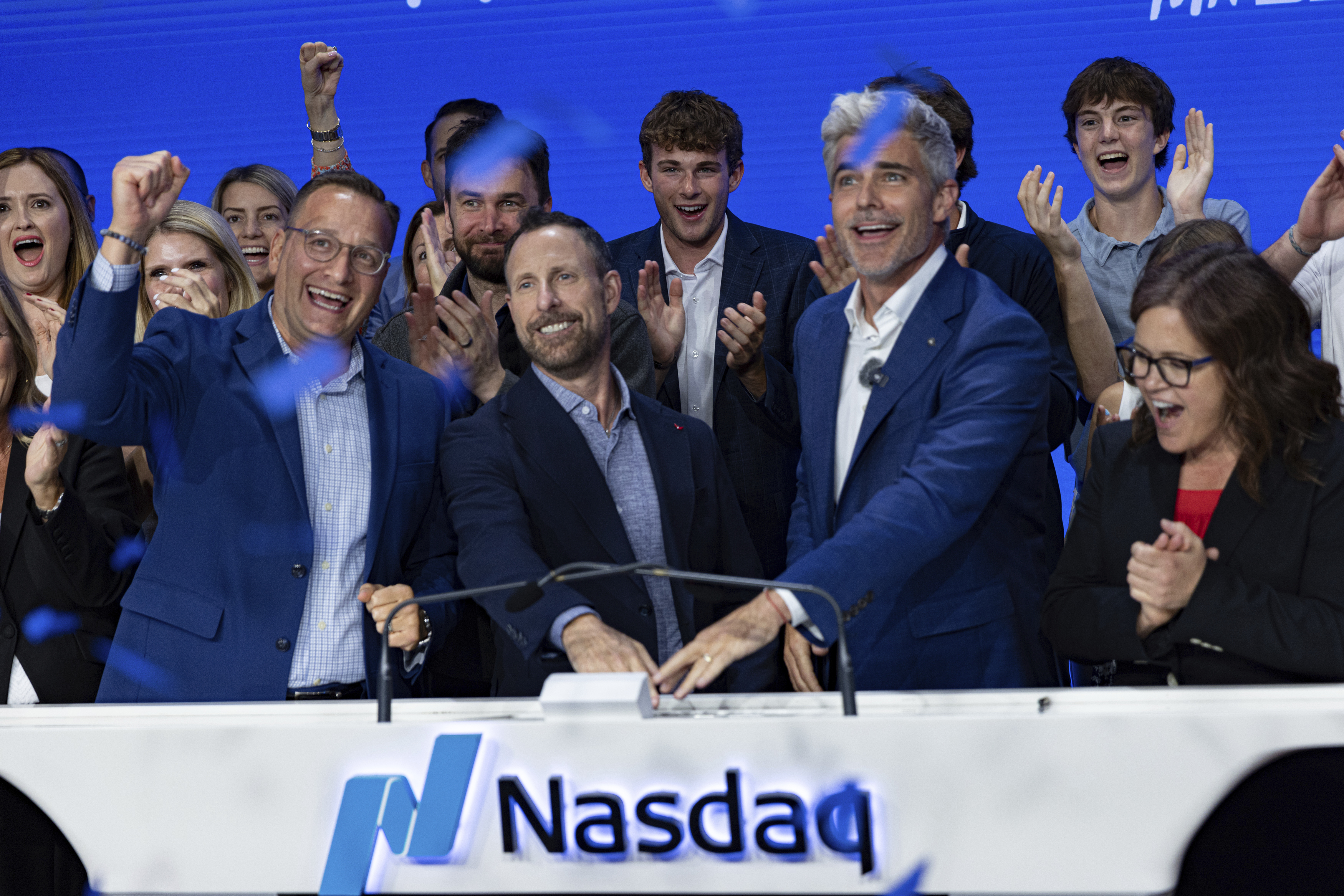 Jeffrey Housenbold, CEO and president of MrBeast, center, participates in a closing bell ceremony with MrBeast's "Beast Games" winner Jeffrey Allen, right, and Joe Brantuk, Nasdaq chief client officer, left, at their studio Wednesday, July 23, 2025, in New York's Times Square. (AP Photo/Stefan Jeremiah)