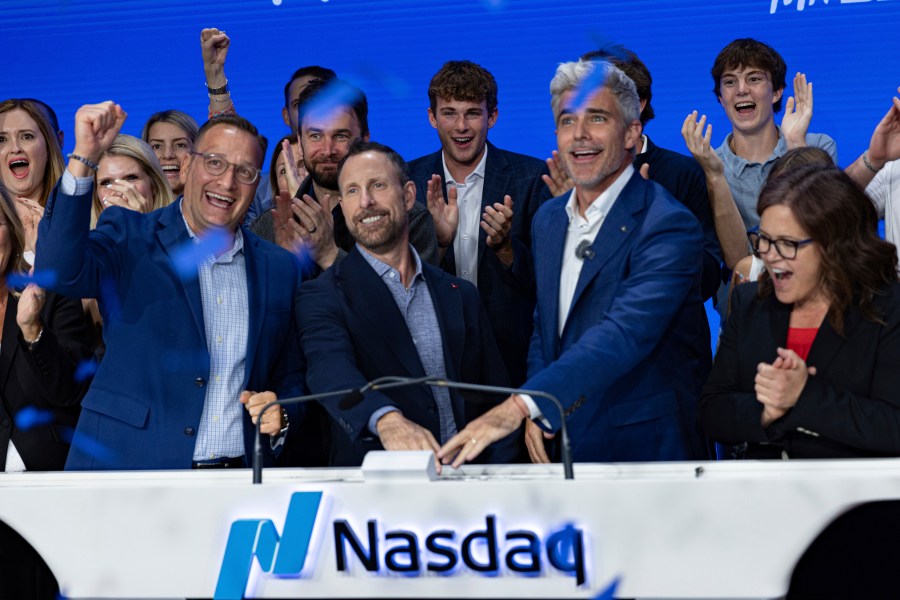 Jeffrey Housenbold, CEO and president of MrBeast, center, participates in a closing bell ceremony with MrBeast's "Beast Games" winner Jeffrey Allen, right, and Joe Brantuk, Nasdaq chief client officer, left, at their studio Wednesday, July 23, 2025, in New York's Times Square. (AP Photo/Stefan Jeremiah)