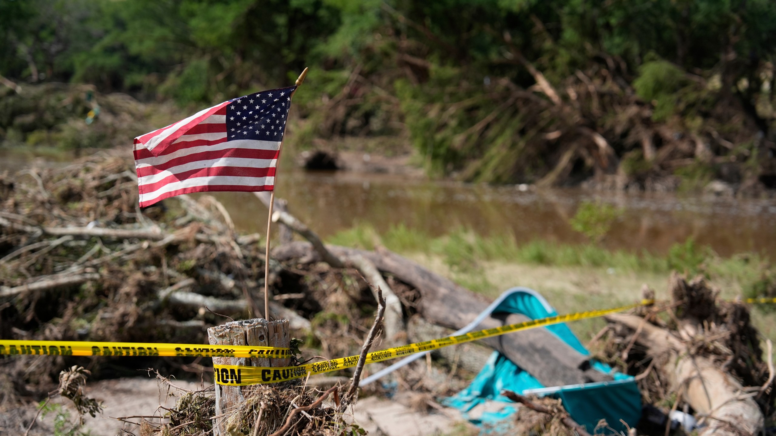 FILE - An American flag is placed on a stump flies in Kerrville, Texas on July 8, 2025. (AP Photo/Ashley Landis, file)