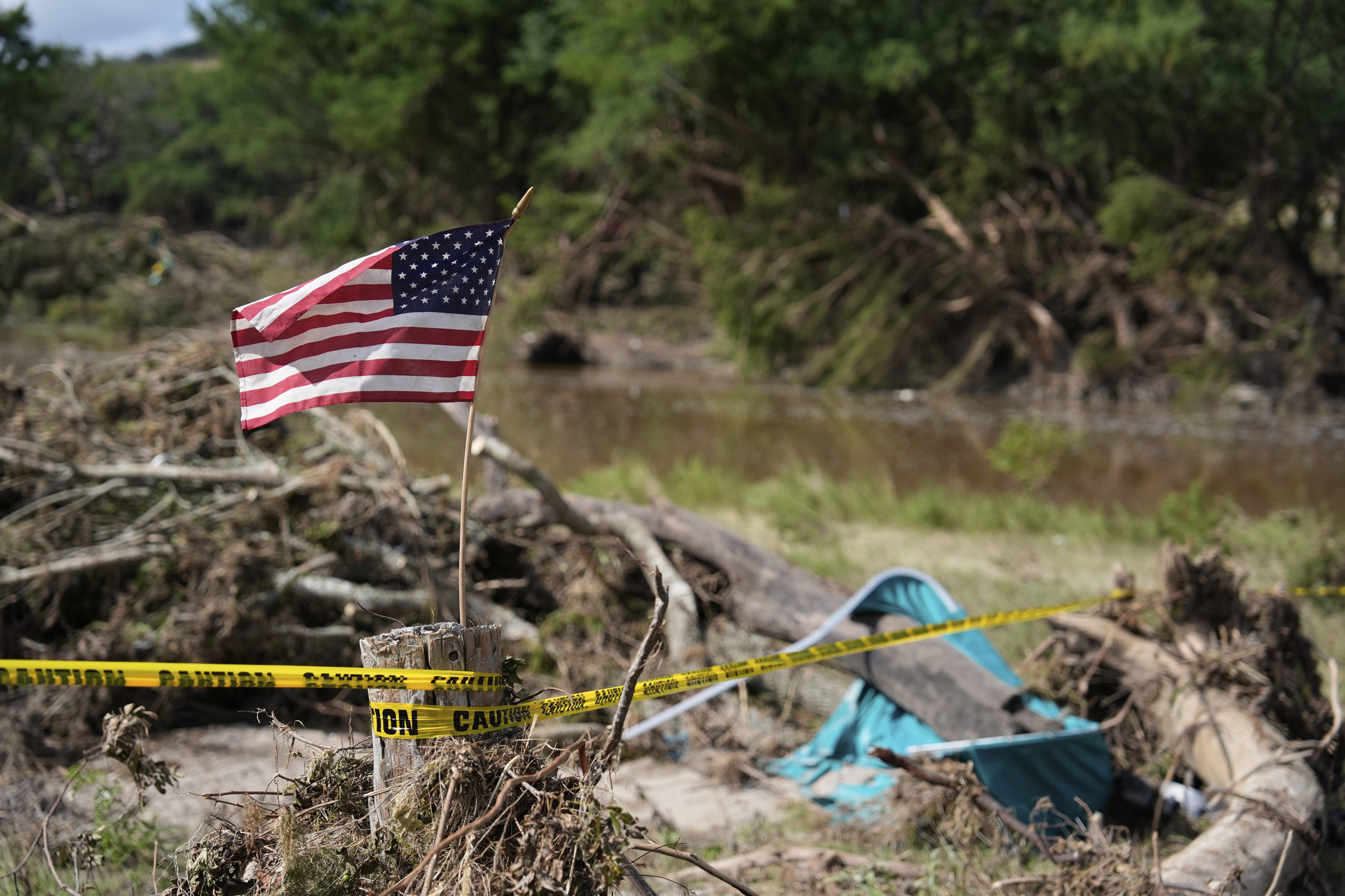 FILE - An American flag is placed on a stump flies in Kerrville, Texas on July 8, 2025. (AP Photo/Ashley Landis, file)