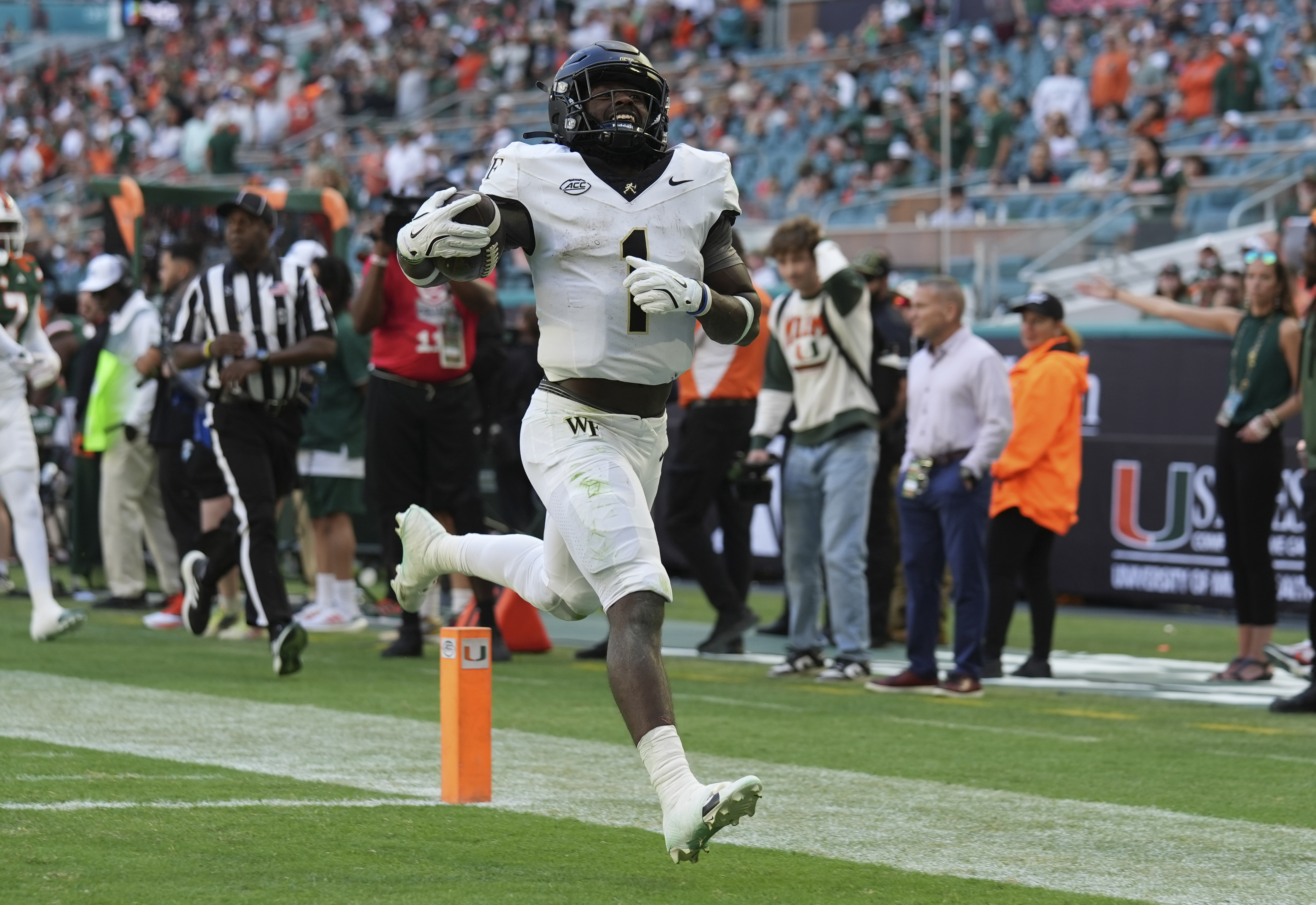 FILE - Wake Forest running back Demond Claiborne (1) runs back a kick return for a touchdown during the first half of an NCAA college football game against Miami, Saturday, Nov. 23, 2024, in Miami Gardens, Fla. (AP Photo/Lynne Sladky, File)