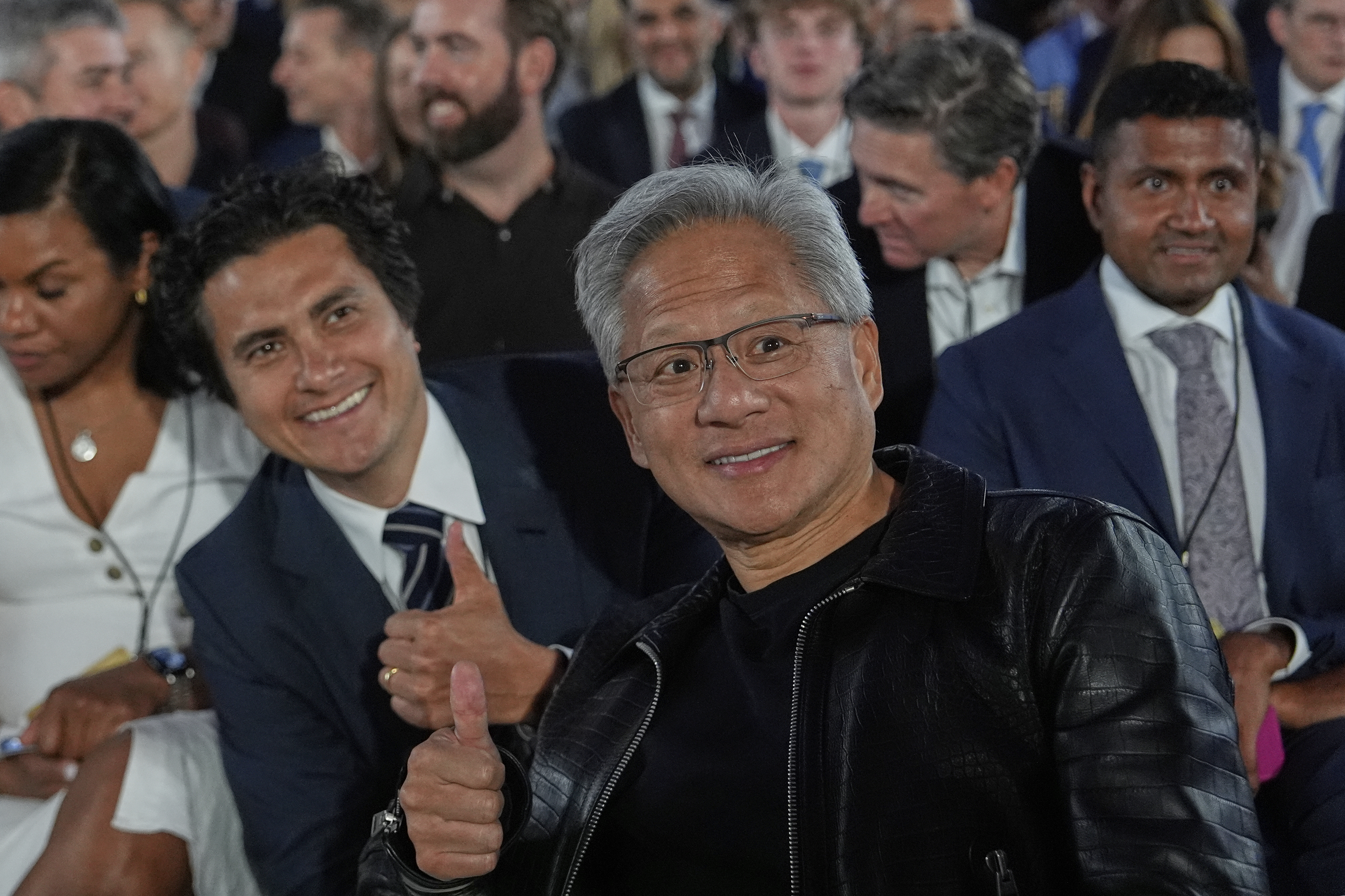 Nvidia CEO Jensen Huang poses for a photo before President Donald Trump speaks during an AI summit at the Andrew W. Mellon Auditorium, Wednesday, July 23, 2025, in Washington. (AP Photo/Julia Demaree Nikhinson)