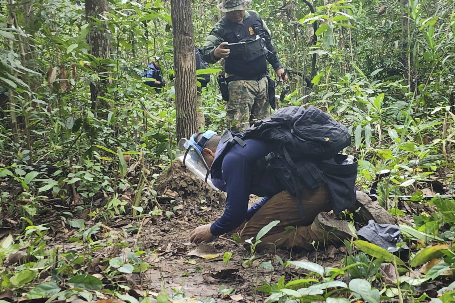 In this Sunday, July, 2025, photo released by the Royal Thai Army, Thai soldiers inspect a border area in Ubon Ratchathani†province where the Royal Thai Army said two anti-personnel landmines were found. (Royal Thai Army via AP)