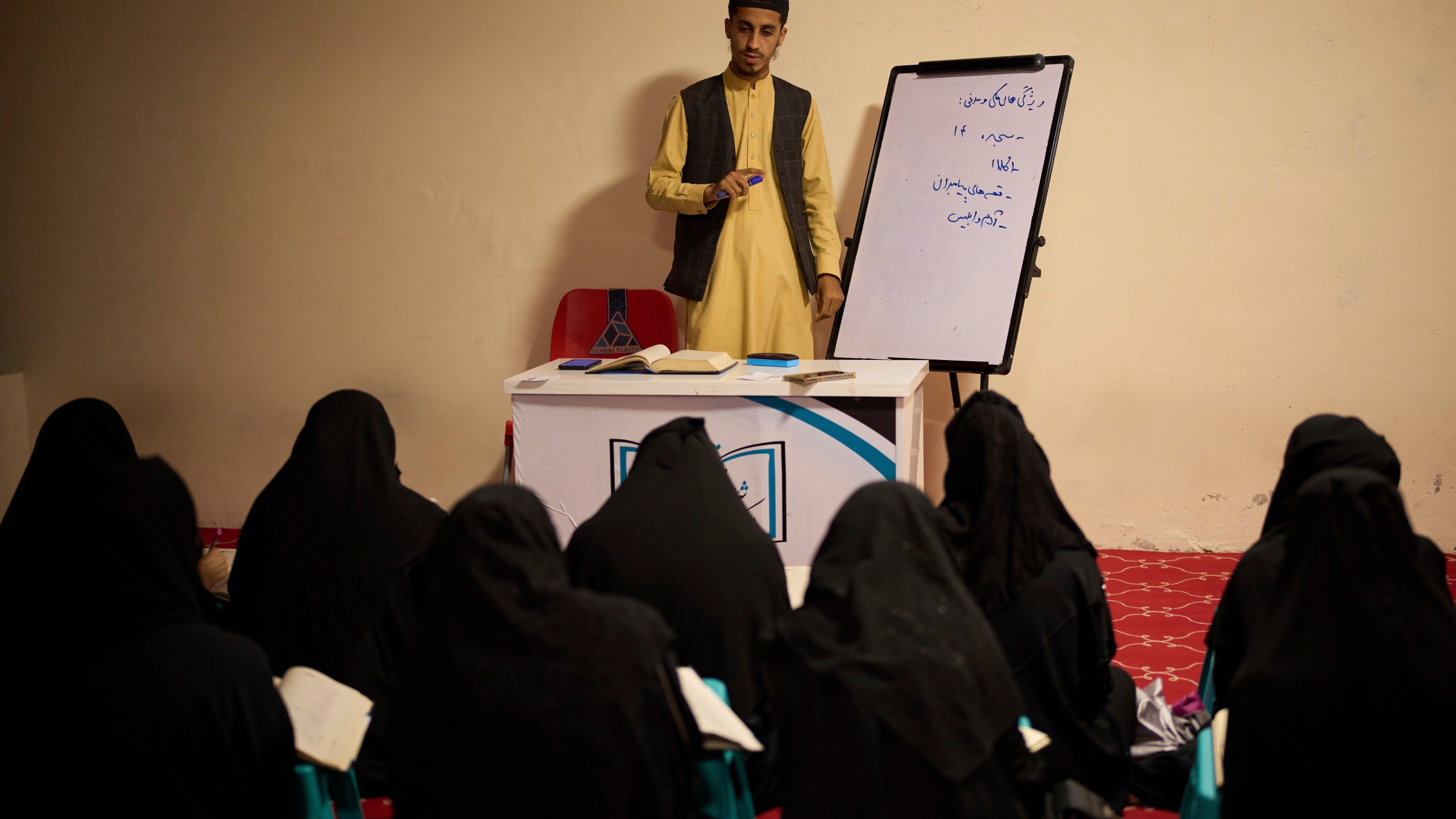 A teacher gives a religious studies lesson to girls at a religious education center in Kabul, Afghanistan, Wednesday, May 28, 2025. (AP Photo/Ebrahim Noroozi)