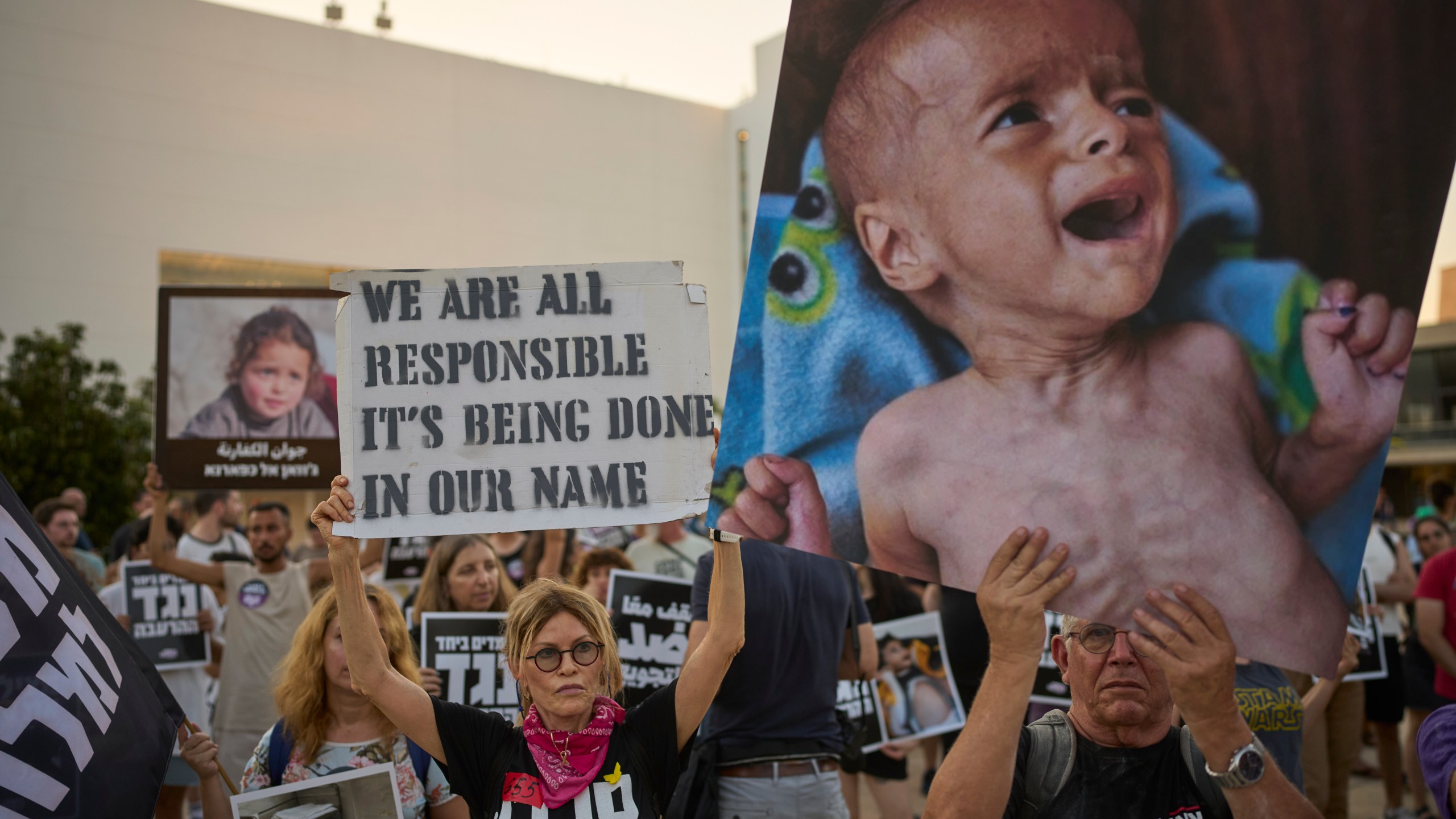 Israeli activists take part in a protest against the war in the Gaza Strip, Israel's measures regarding food distribution and the forced displacement of Palestinians, in Tel Aviv, Israel, Tuesday, July 22, 2025. (AP Photo/Ohad Zwigenberg)