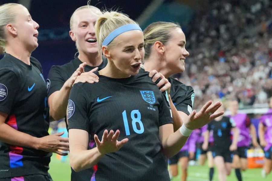 England's Chloe Kelly is celebrated after she scored the decisive second goal for England during the Women's Euro 2025 semifinals soccer match between England and Italy at Stade de Geneve in Geneva, Switzerland, Tuesday, July 22, 2025. (AP Photo/Martin Meissner)