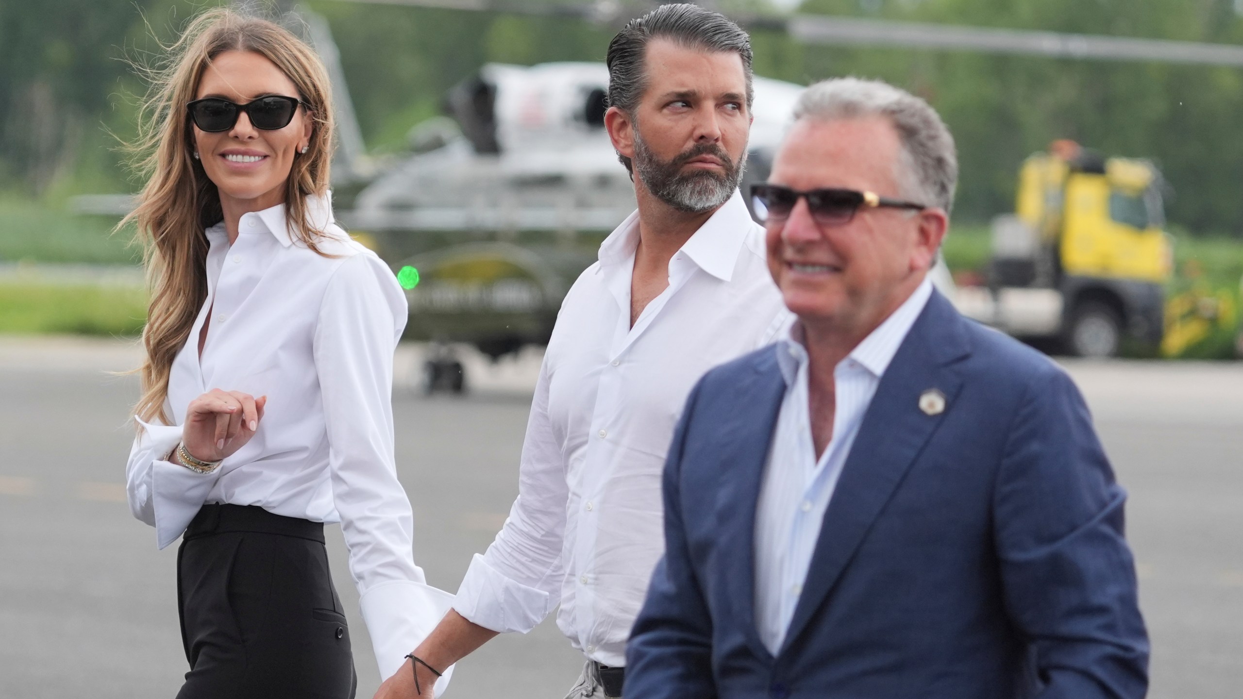 White House special envoy Steve Witkoff, from right, Donald Trump Jr., and Bettina Anderson watch as President Donald Trump arrives at Teterboro Airport in Teterboro, N.J., en route to attend the Club World Cup final soccer match, Sunday, July 13, 2025. (AP Photo/Jacquelyn Martin)