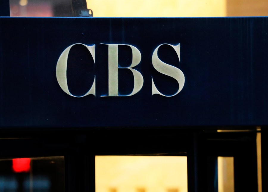 FILE - The CBS logo at the entrance to its headquarters, in New York Dec. 6, 2018. (AP Photo/Mark Lennihan, File)