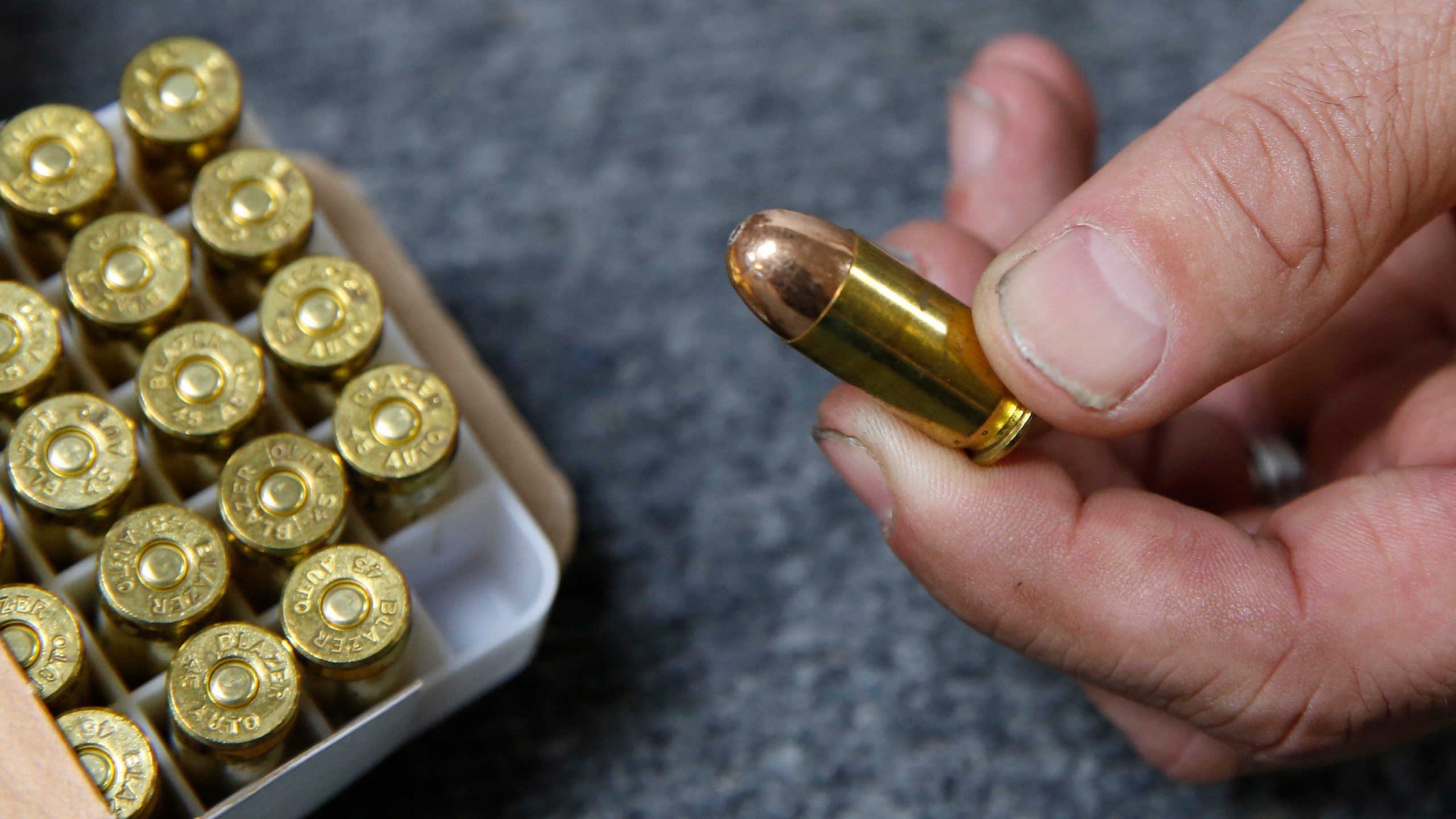 FILE - Chris Puehse, owner of Foothill Ammo, displays .45-caliber ammunition for sale at his store in Shingle Springs, Calif., June 11, 2019. (AP Photo/Rich Pedroncelli, File)