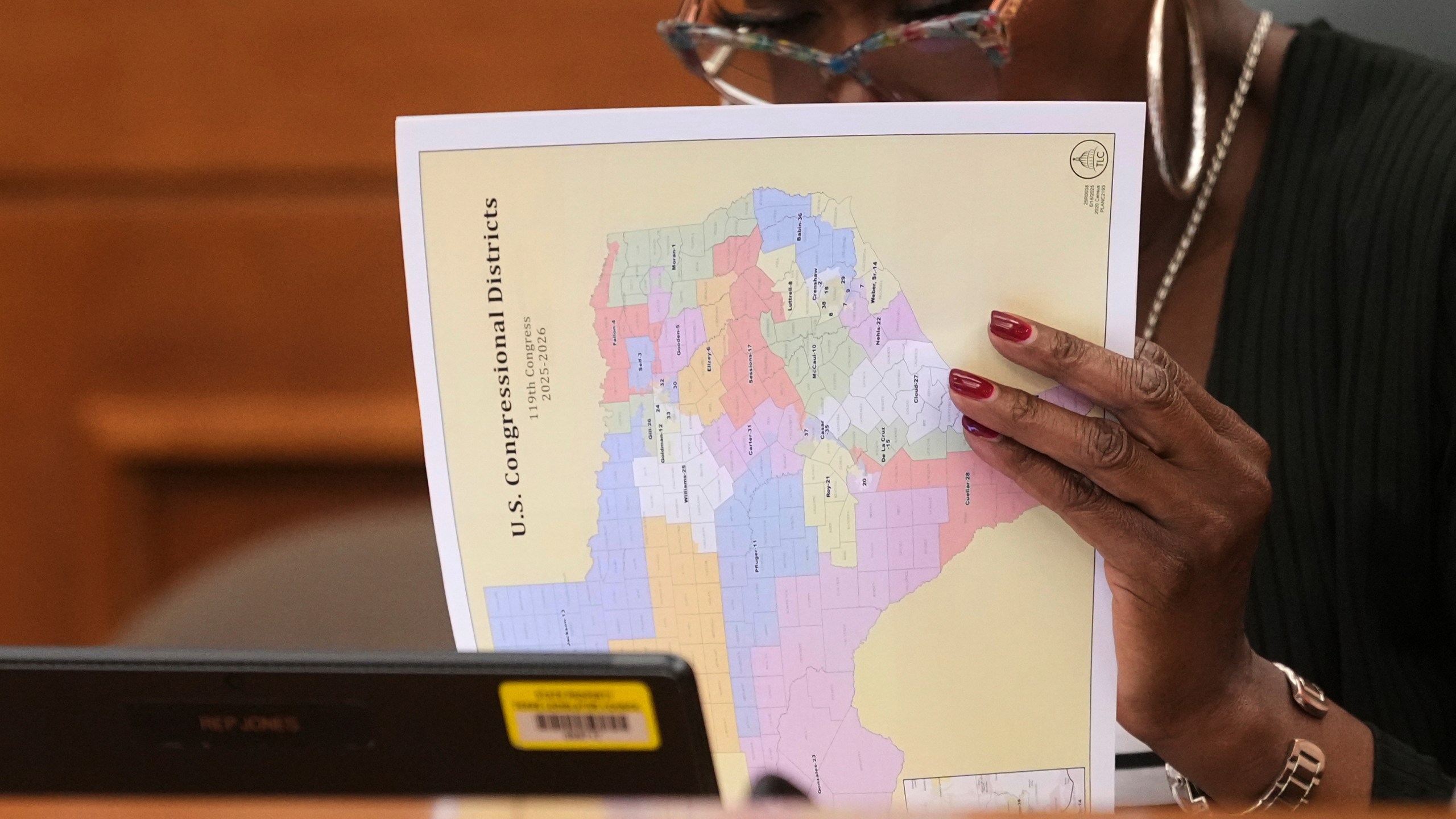 Texas state Rep. Jolanda "Jo" Jones looks through U.S. Congressional District maps during a redistricting hearing at the Texas Capitol, Thursday, July 24, 2025, in Austin, Texas. (AP Photo/Eric Gay)