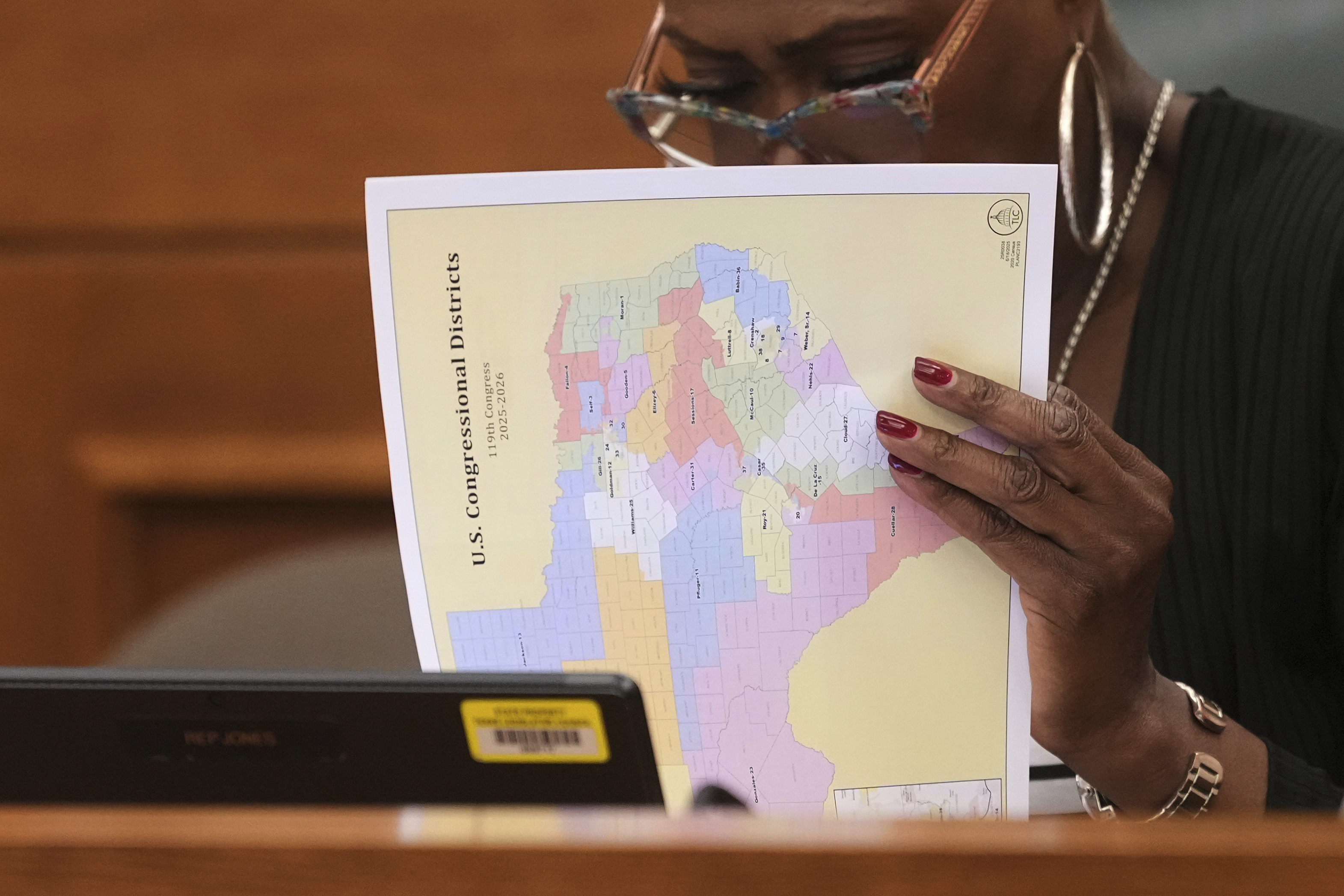Texas state Rep. Jolanda "Jo" Jones looks through U.S. Congressional District maps during a redistricting hearing at the Texas Capitol, Thursday, July 24, 2025, in Austin, Texas. (AP Photo/Eric Gay)