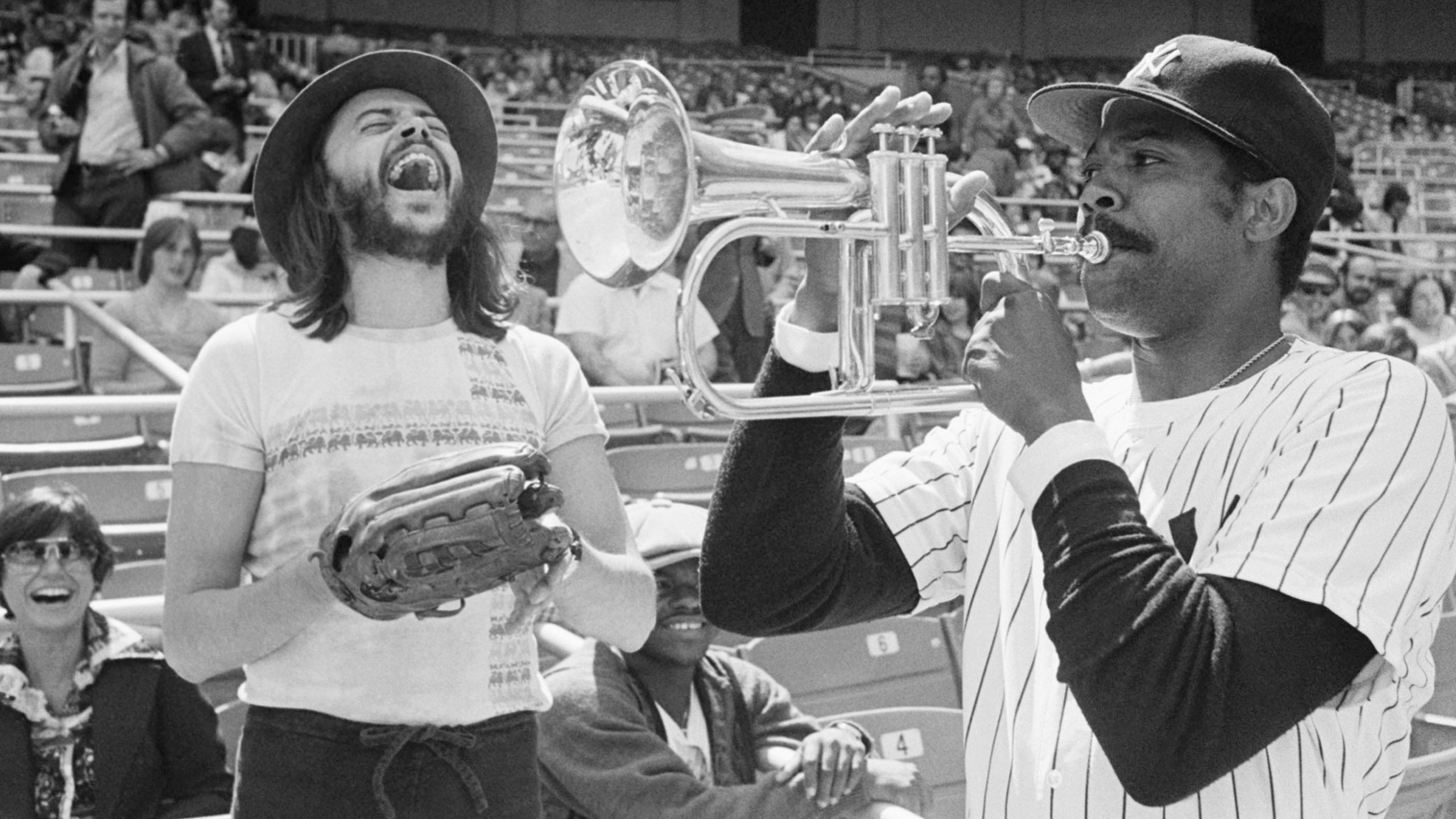 FILE - New York Yankees Pitcher Dock Ellis, right, has a little fun with a Chuck Mangione's horn before a game with the Toronto Blue Jays at Yankee Stadium, April 19, 1977, in New York. (AP Photo/Ray Stubblebine, file)