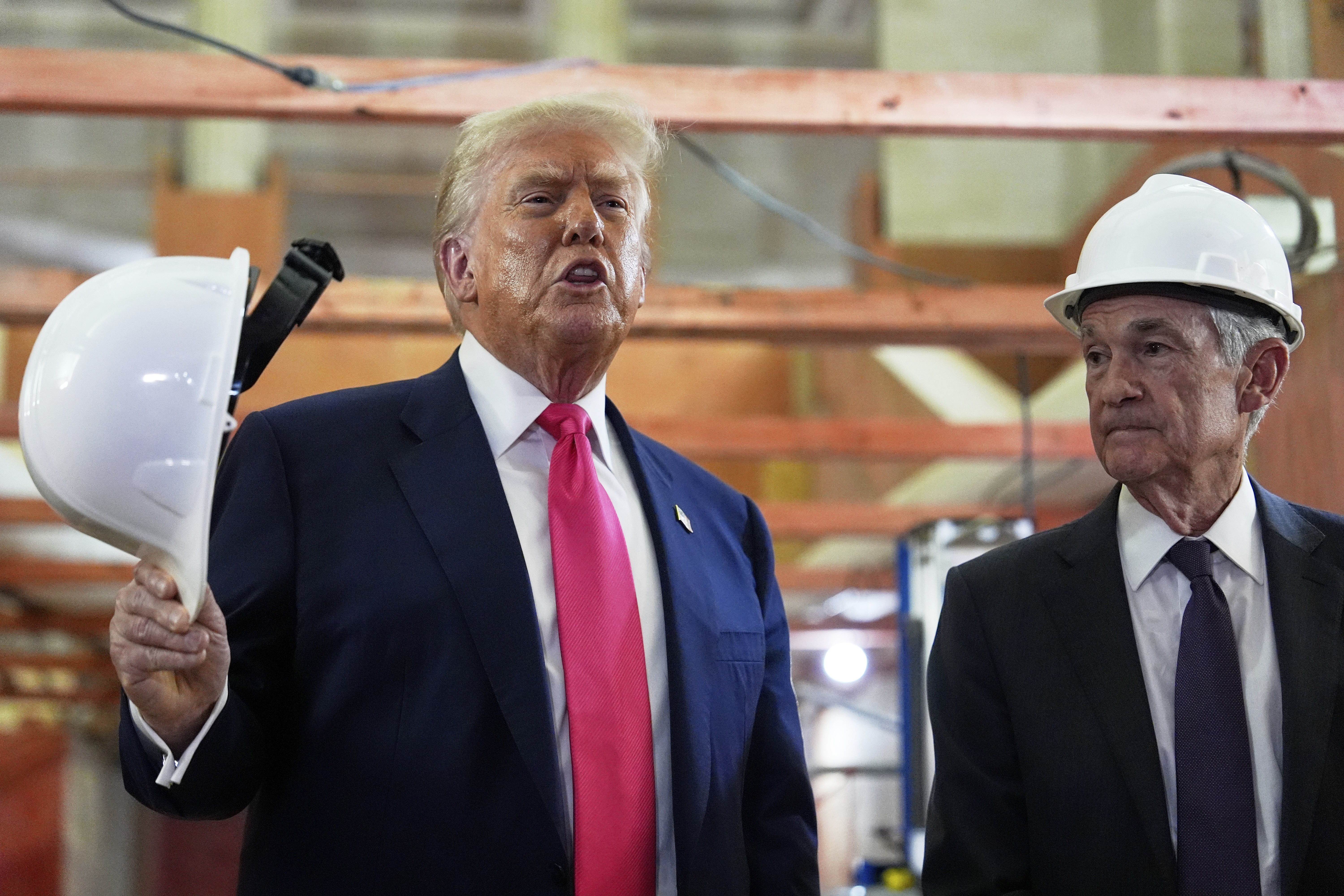 President Donald Trump speaks as Federal Reserve Chairman Jerome Powell listens during a visit to the Federal Reserve, Thursday, July 24, 2025, in Washington. (AP Photo/Julia Demaree Nikhinson)