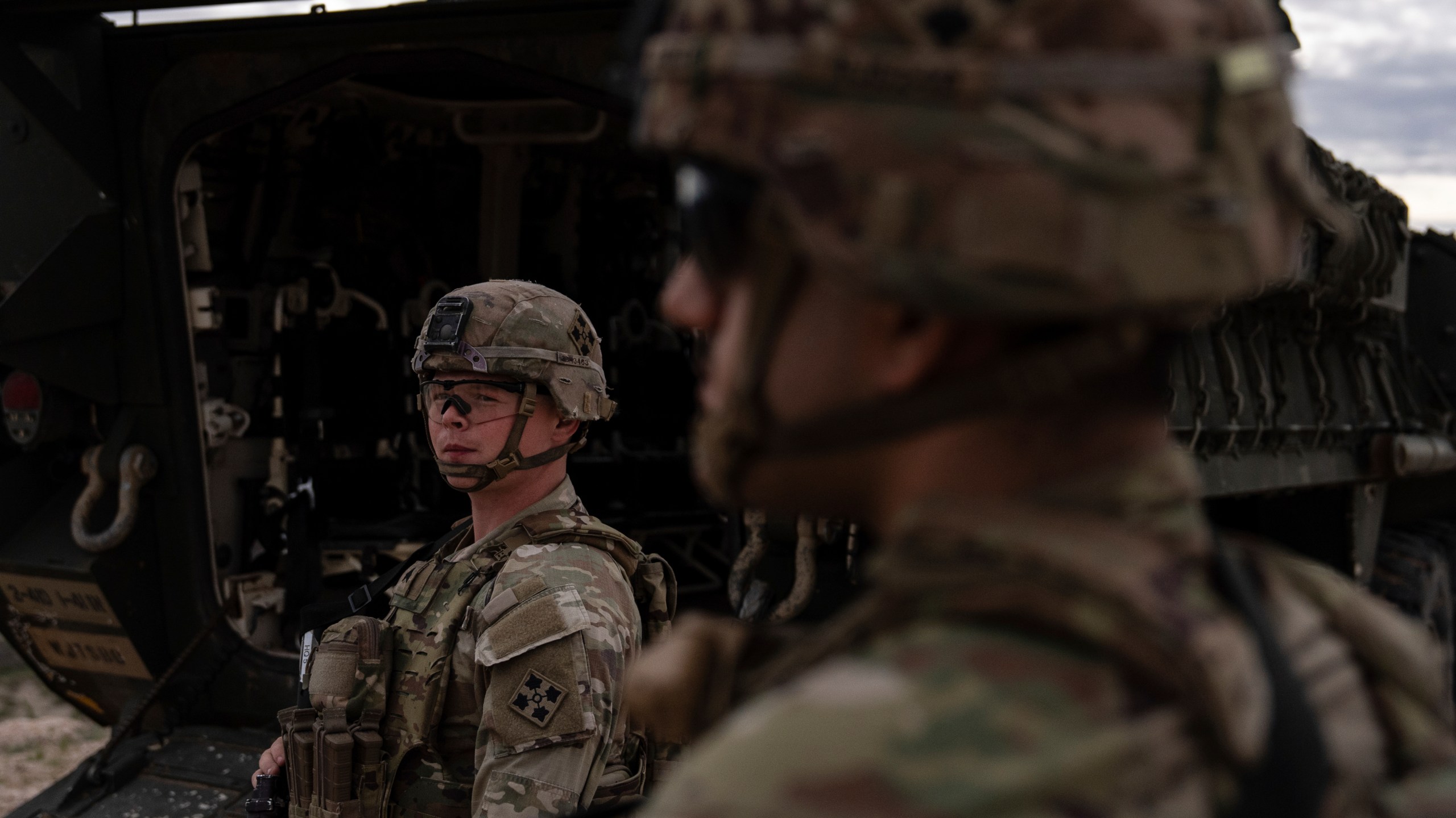 U.S Army Sgt. Brenden Richards monitors the area while standing next to a Stryker combat vehicle Wednesday, July 23, 2025, in Sunland Park, N.M. (AP Photo/Jae C. Hong)