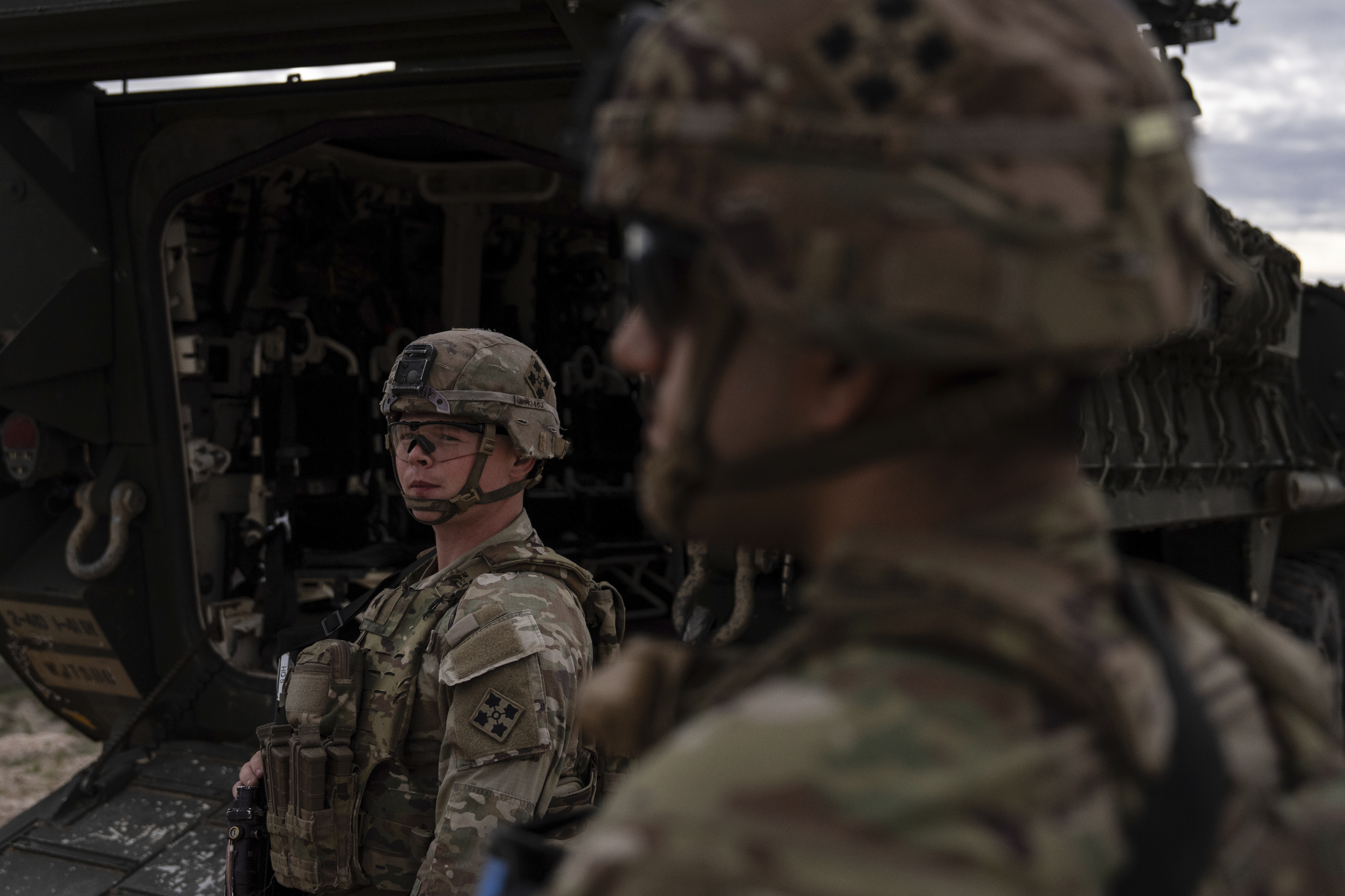 U.S Army Sgt. Brenden Richards monitors the area while standing next to a Stryker combat vehicle Wednesday, July 23, 2025, in Sunland Park, N.M. (AP Photo/Jae C. Hong)