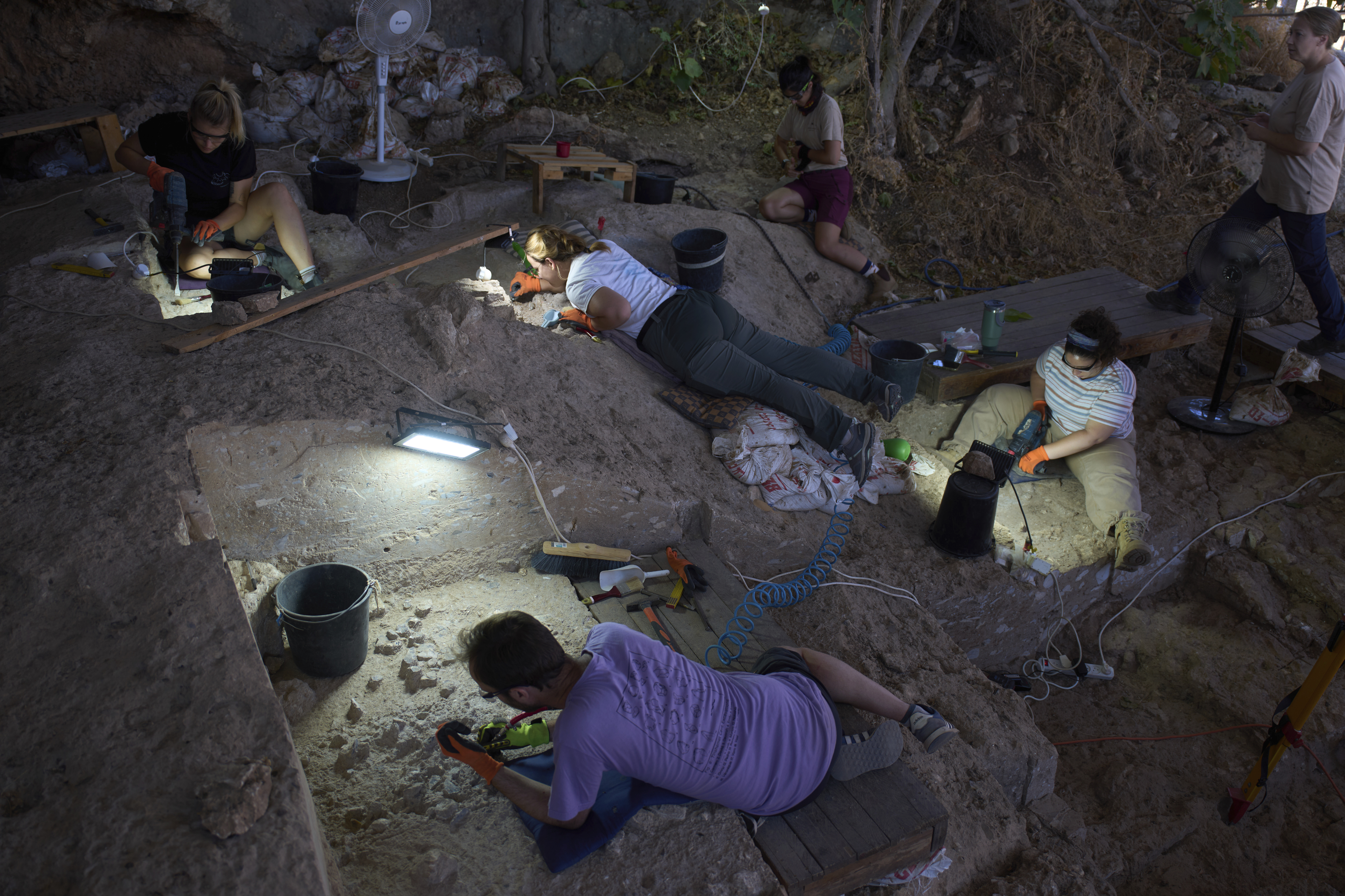Volunteers work in Tinshemet Cave, where archaeologists are excavating one of the world's oldest known burial sites, dating back 100,000 years, near Shoam, Israel, Tuesday, July 15, 2025. (AP Photo/Ariel Schalit)