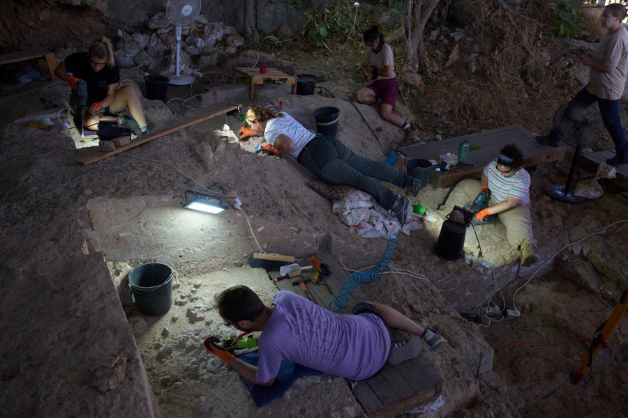 Volunteers work in Tinshemet Cave, where archaeologists are excavating one of the world's oldest known burial sites, dating back 100,000 years, near Shoam, Israel, Tuesday, July 15, 2025. (AP Photo/Ariel Schalit)
