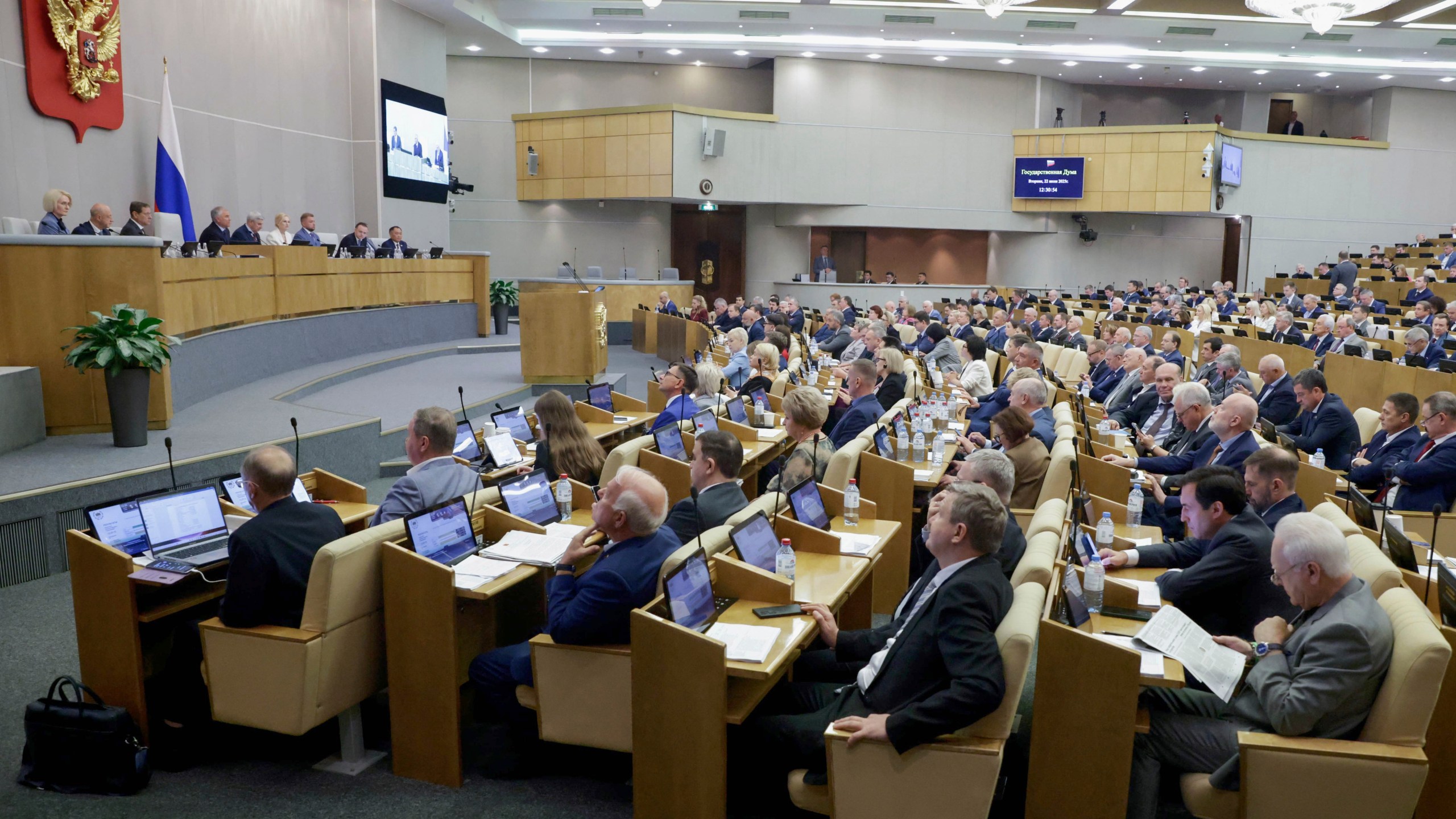 In this photo released by the State Duma, deputies attend a session at the State Duma, the lower house of the Russian parliament, in Moscow, Russia, Tuesday, July 22, 2025. (The State Duma, Lower House of the Russian Parliament Press Service via AP)