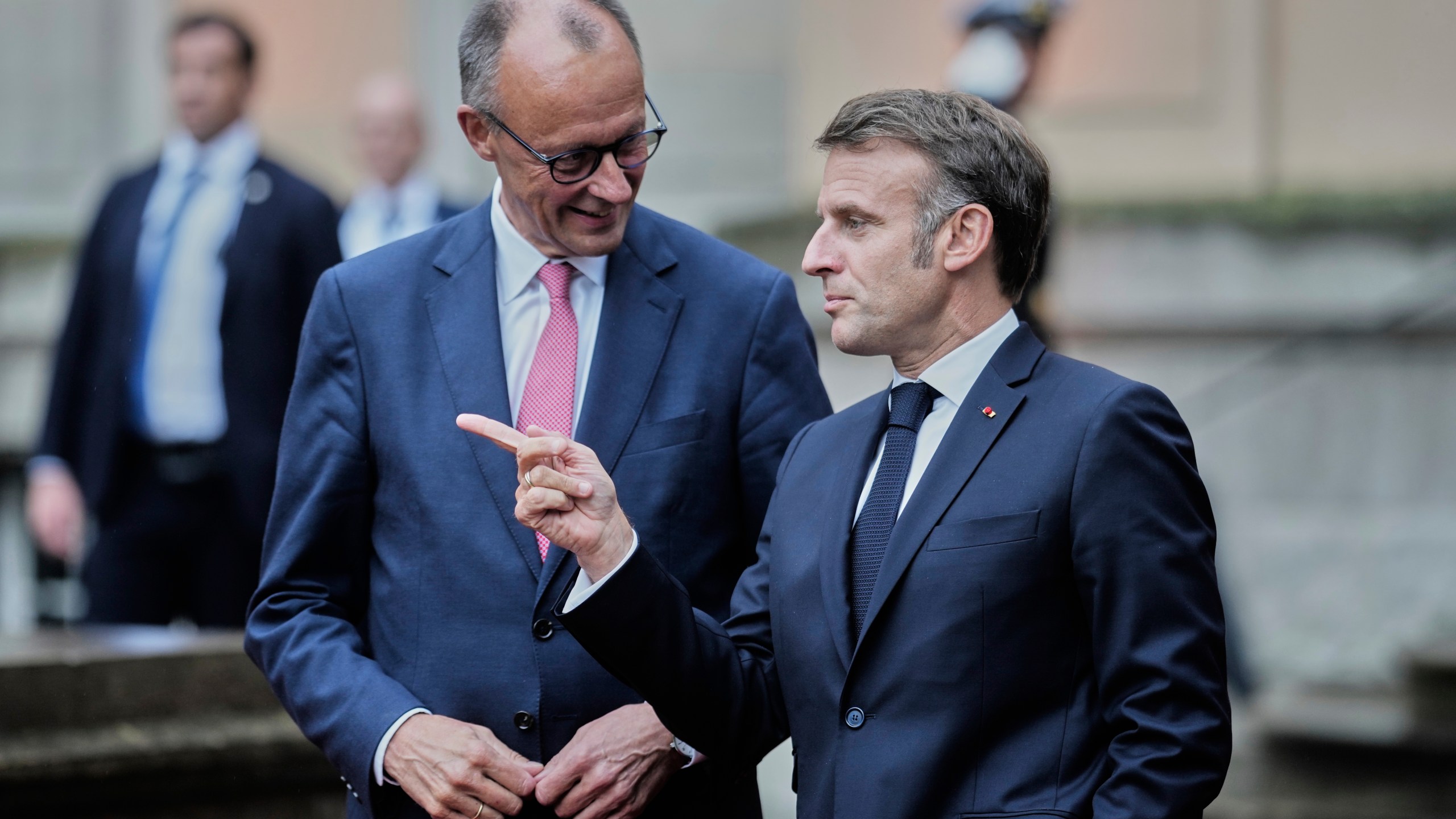 German Chancellor Friedrich Merz, left, welcomes French President Emmanuel Macron at the Foreign Ministry's guest house Villa Borsig in Berlin, Germany, Wednesday, July 23, 2025. (AP Photo/Markus Schreiber)